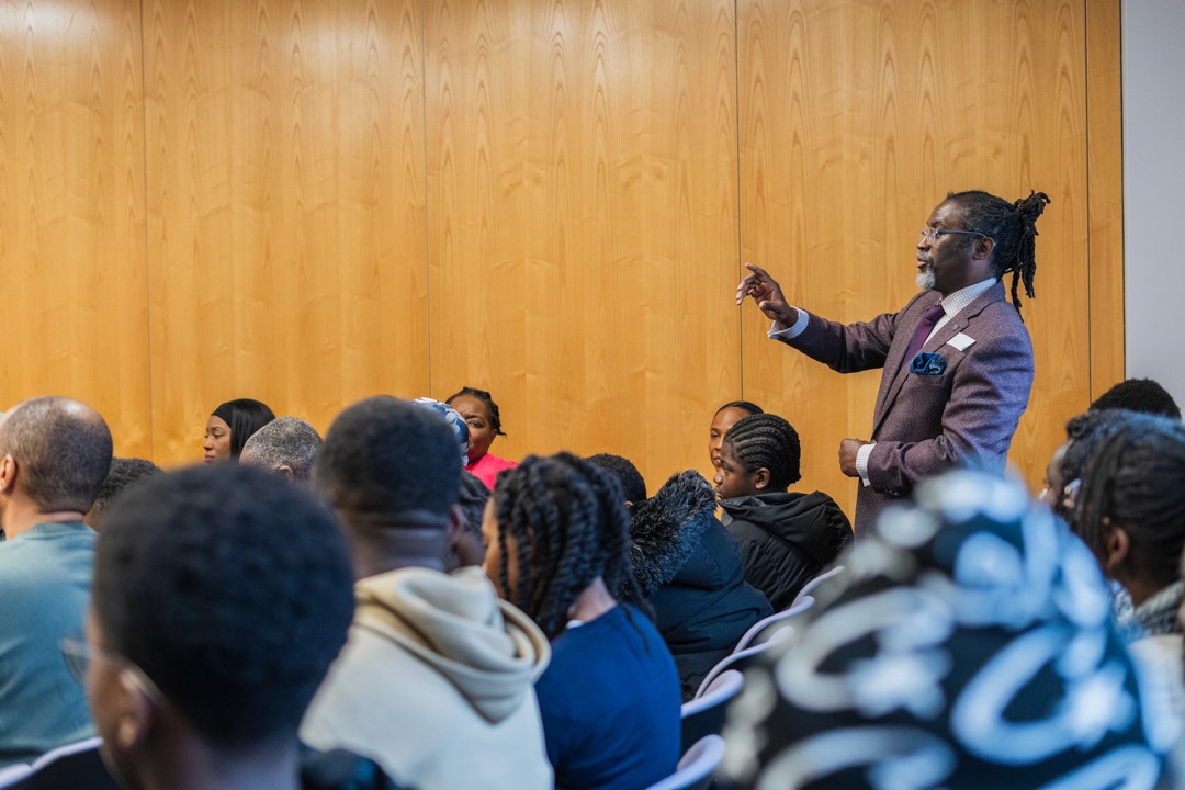 A parent asks a question at a Q&A panel at an event in London