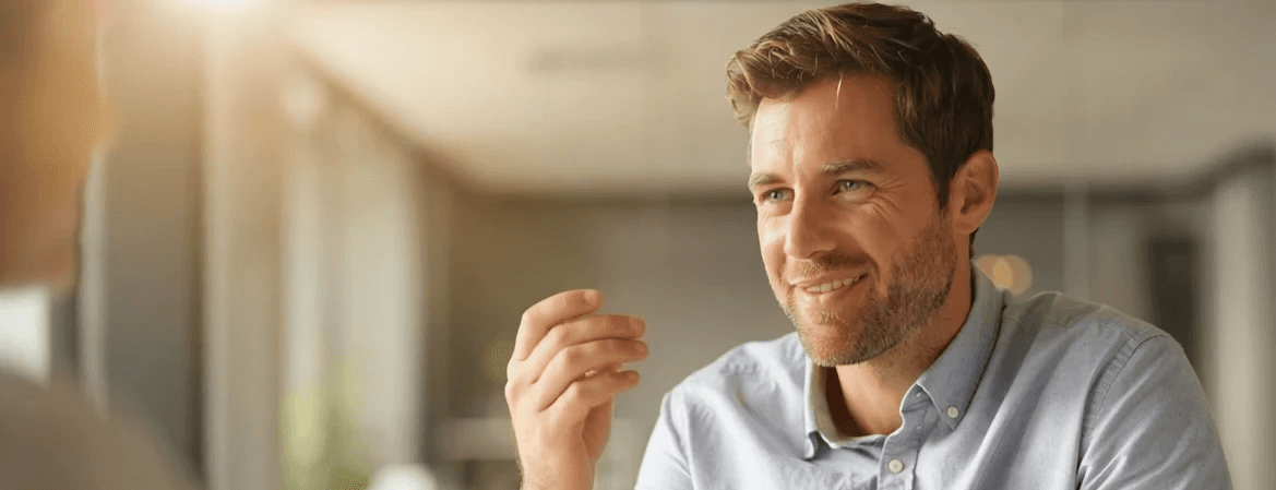 Man talking to someone at desk