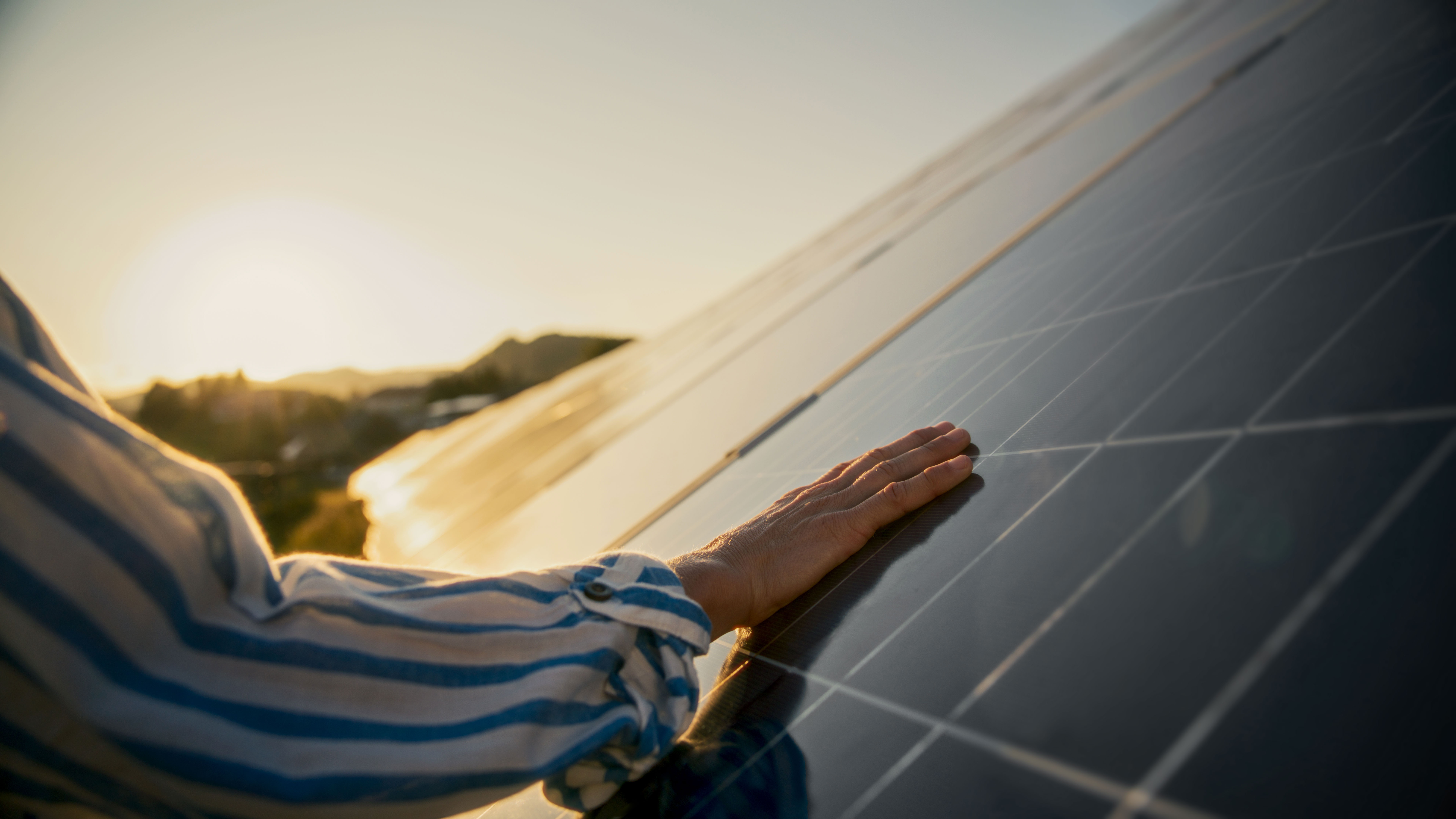 A person touching a solar module