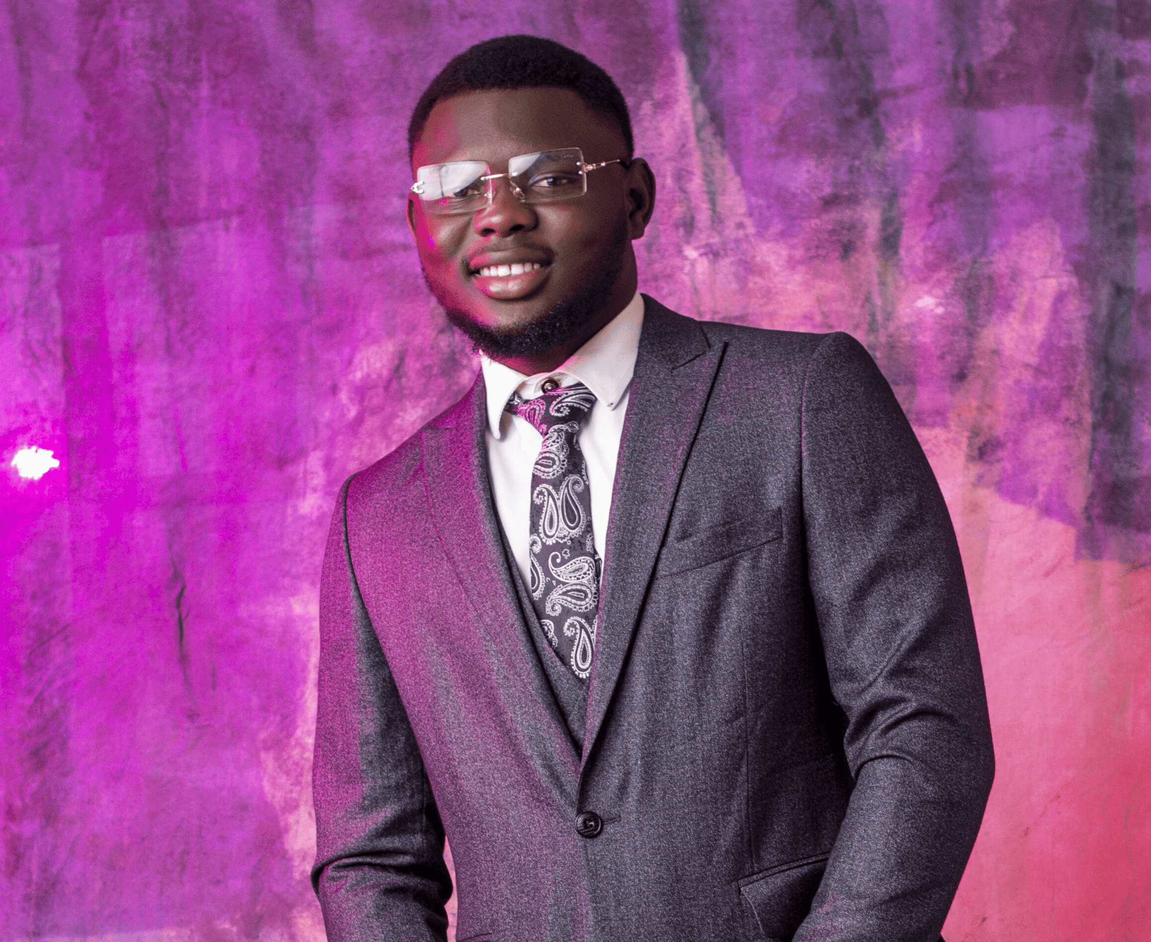 Emmanuel smiling in a pose