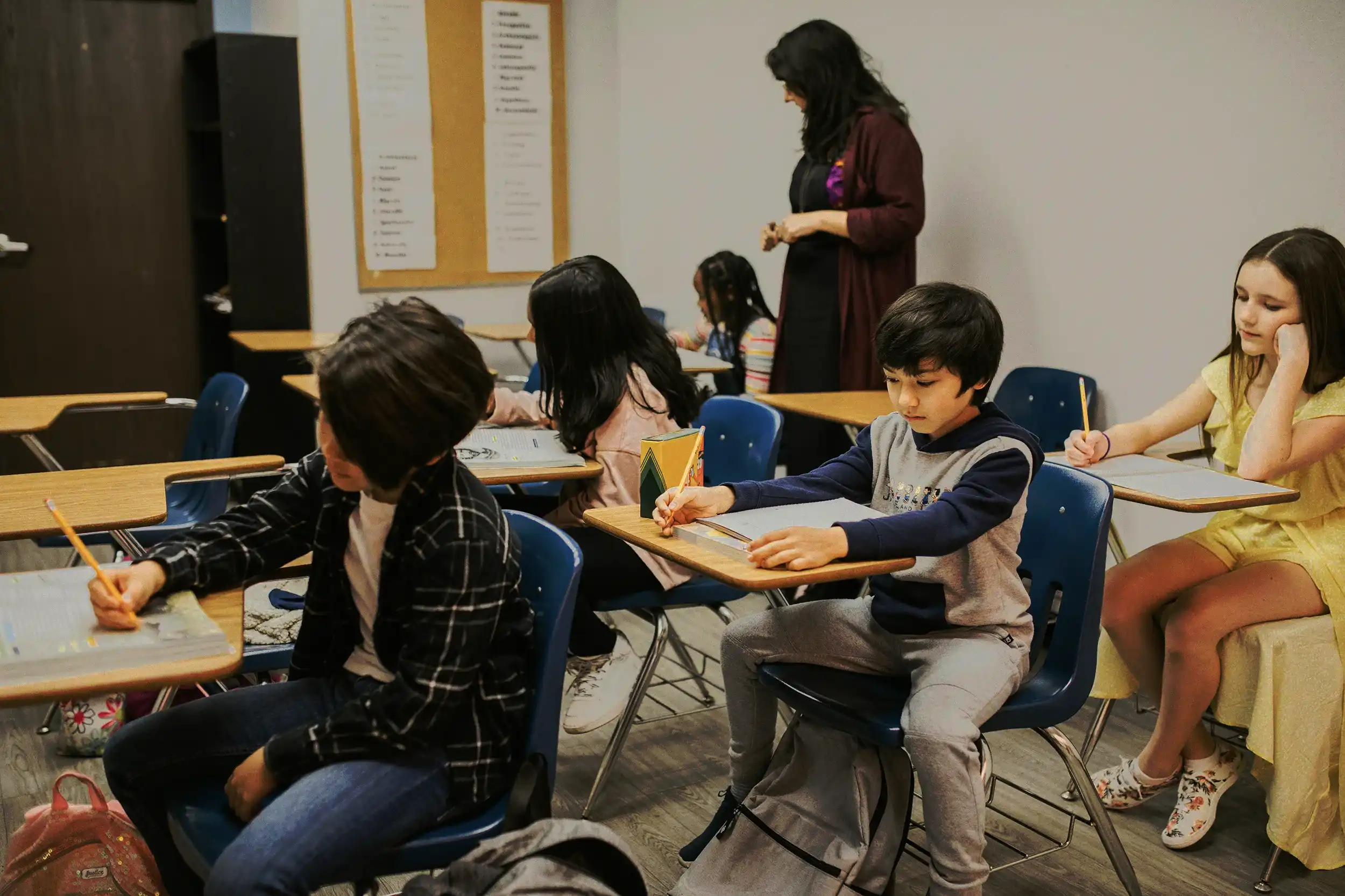 Classroom of elementary school students with teacher, representing safe learning environment through school security services