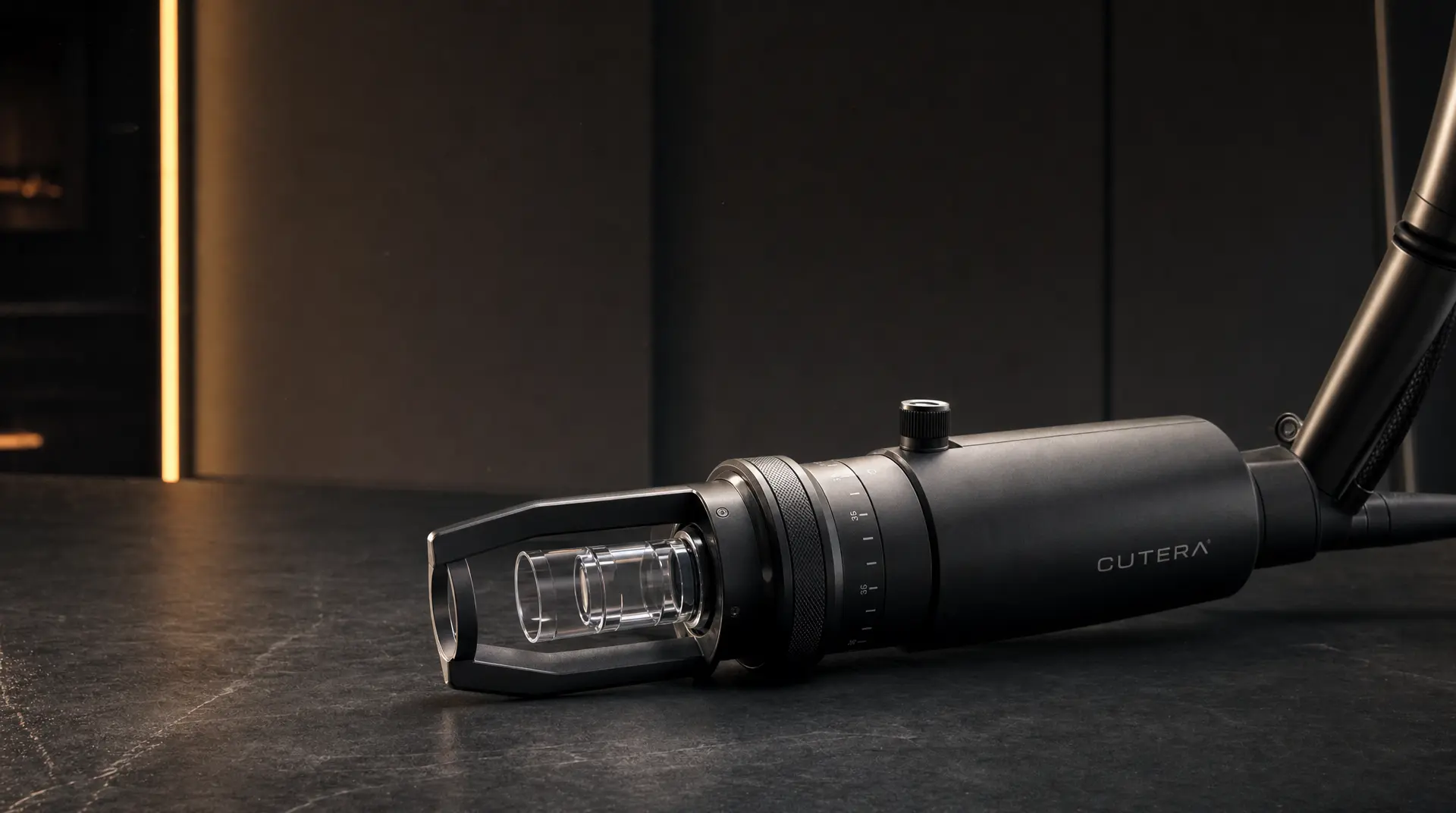 A sleek Cutera laser device with adjustment dials rests on a dark studio floor under warm vertical light, highlighting medtech marketing and medical device marketing strategy.