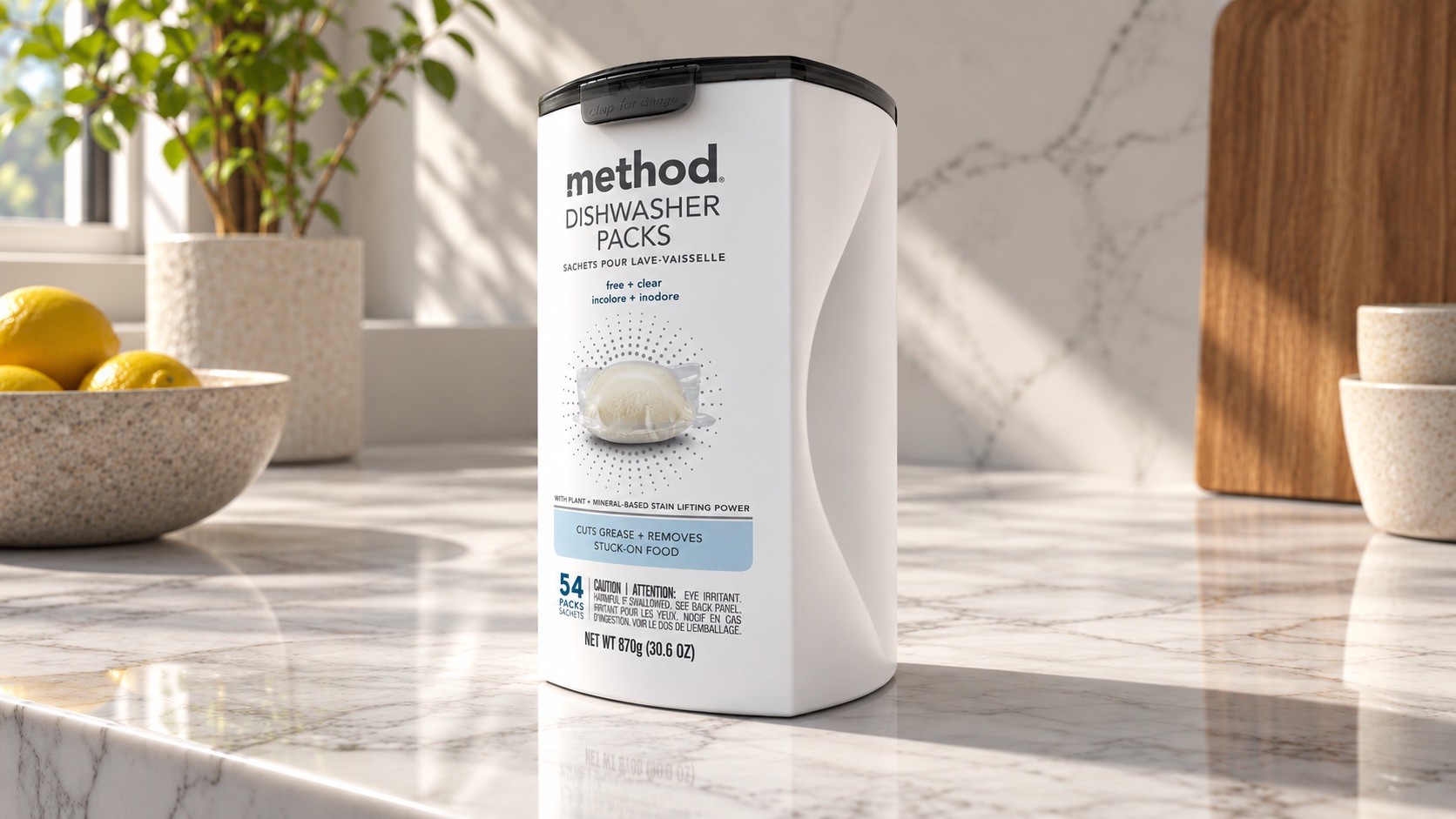 White canister with a smoky clip-shut lid on a marble kitchen counter in morning light, lemons and a plant behind
