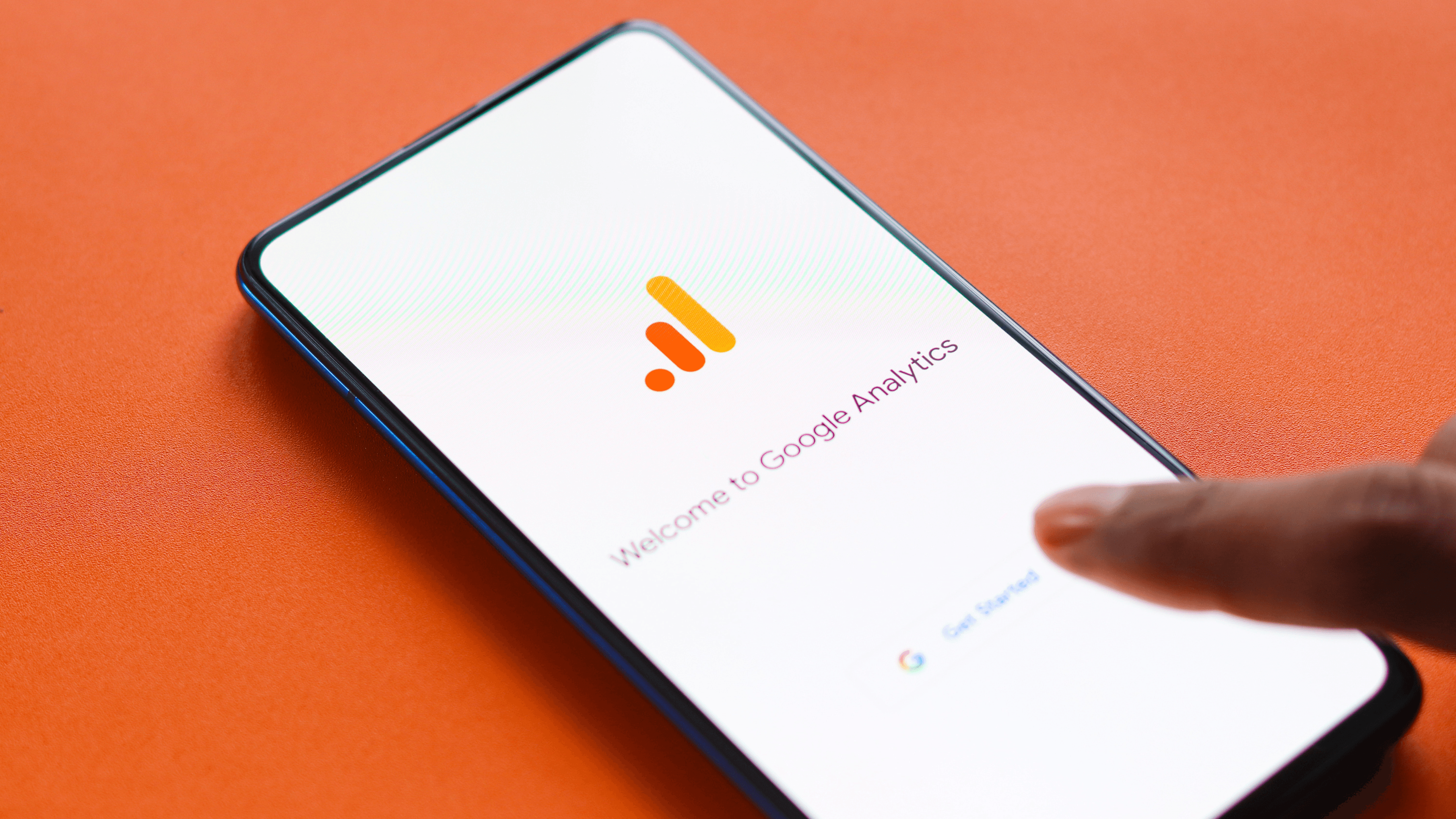 Hand touching phone on Google Analytics