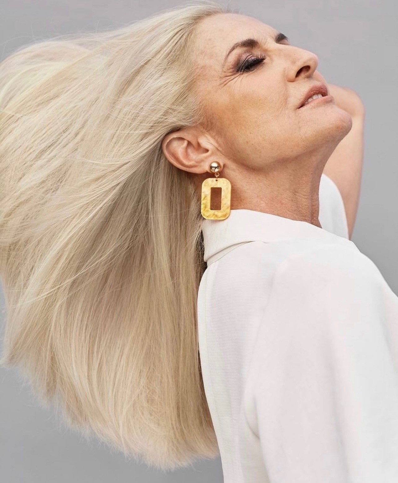 Platinum blonde hair color for gray coverage at Bomane Salon – bright, healthy shine for mature women.