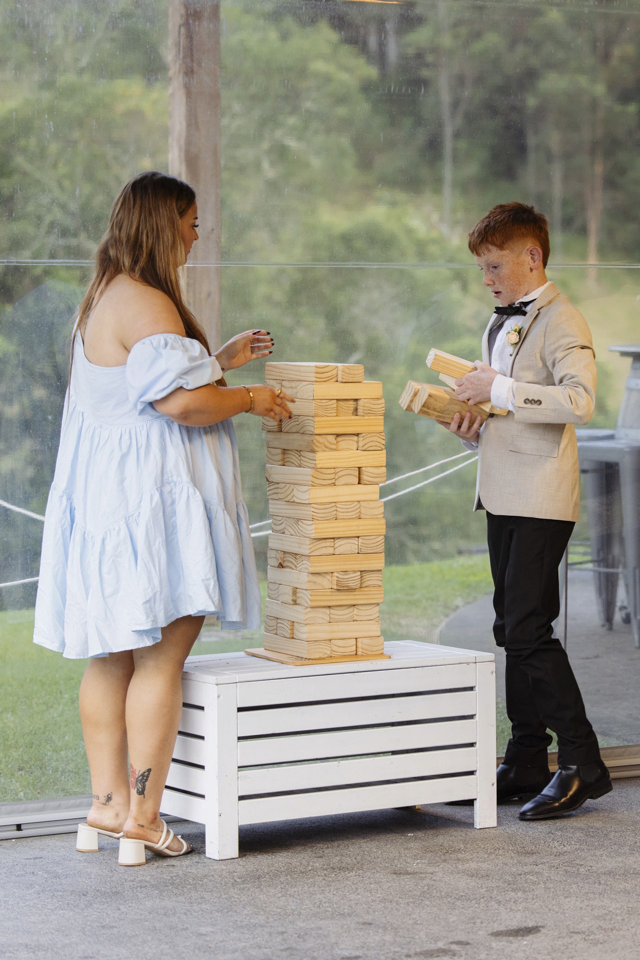 Woman and young boy playing jenga