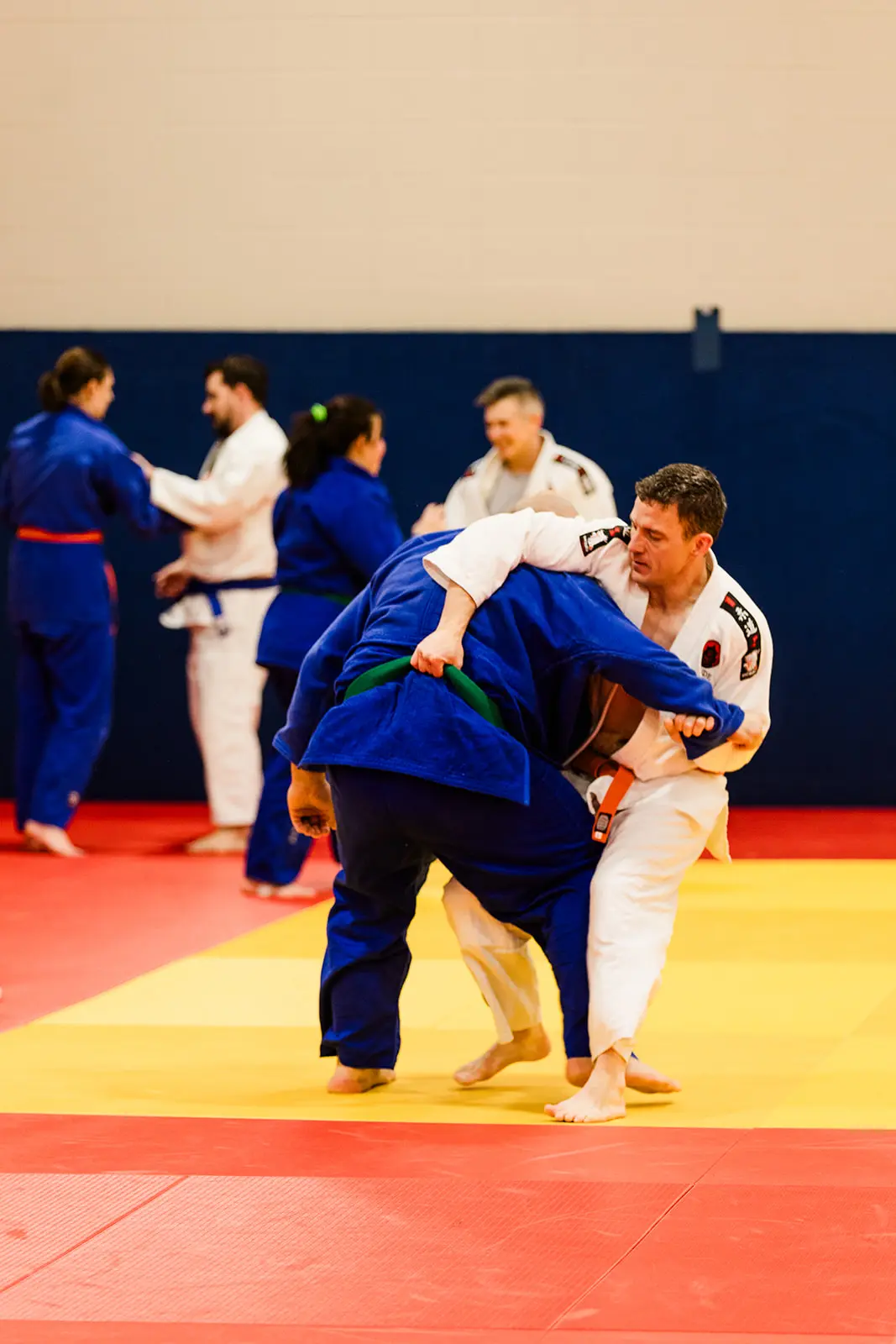 Two members of adult judo class engaging in randori