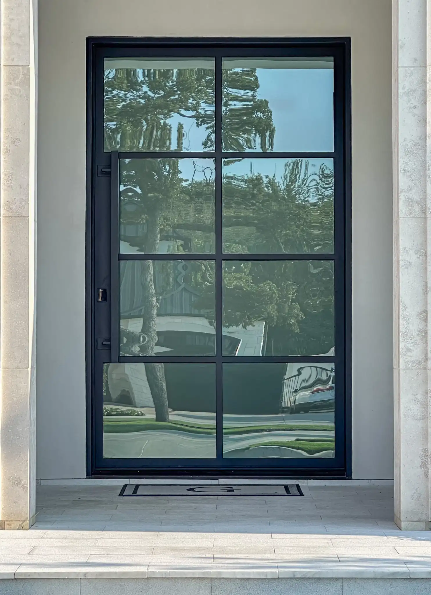 8 lite pivot steel door installed on a DFW home by M2 Metals Iron Doors