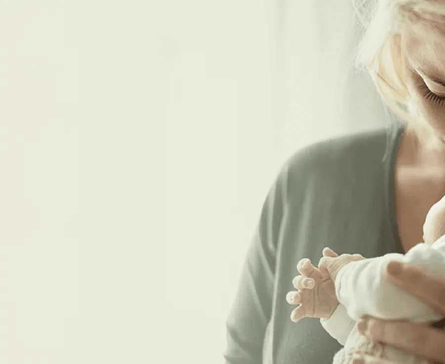 Woman with her baby representing the postpartum care path