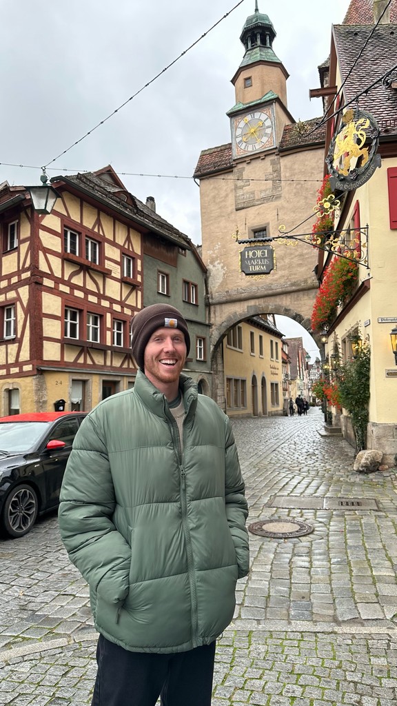 Young man standing in front of German buildings