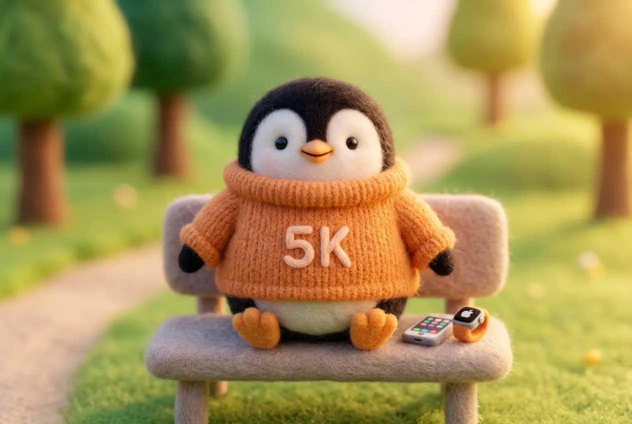 A cute wool felt penguin mascot wearing an orange sweater, sitting on a park bench with an iPhone and Apple Watch nearby