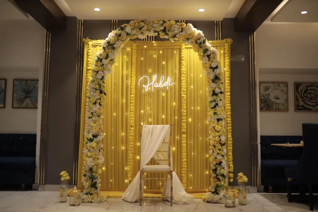 Yellow Arch U shape decor for Haldi at Home in Delhi NCR by Decori