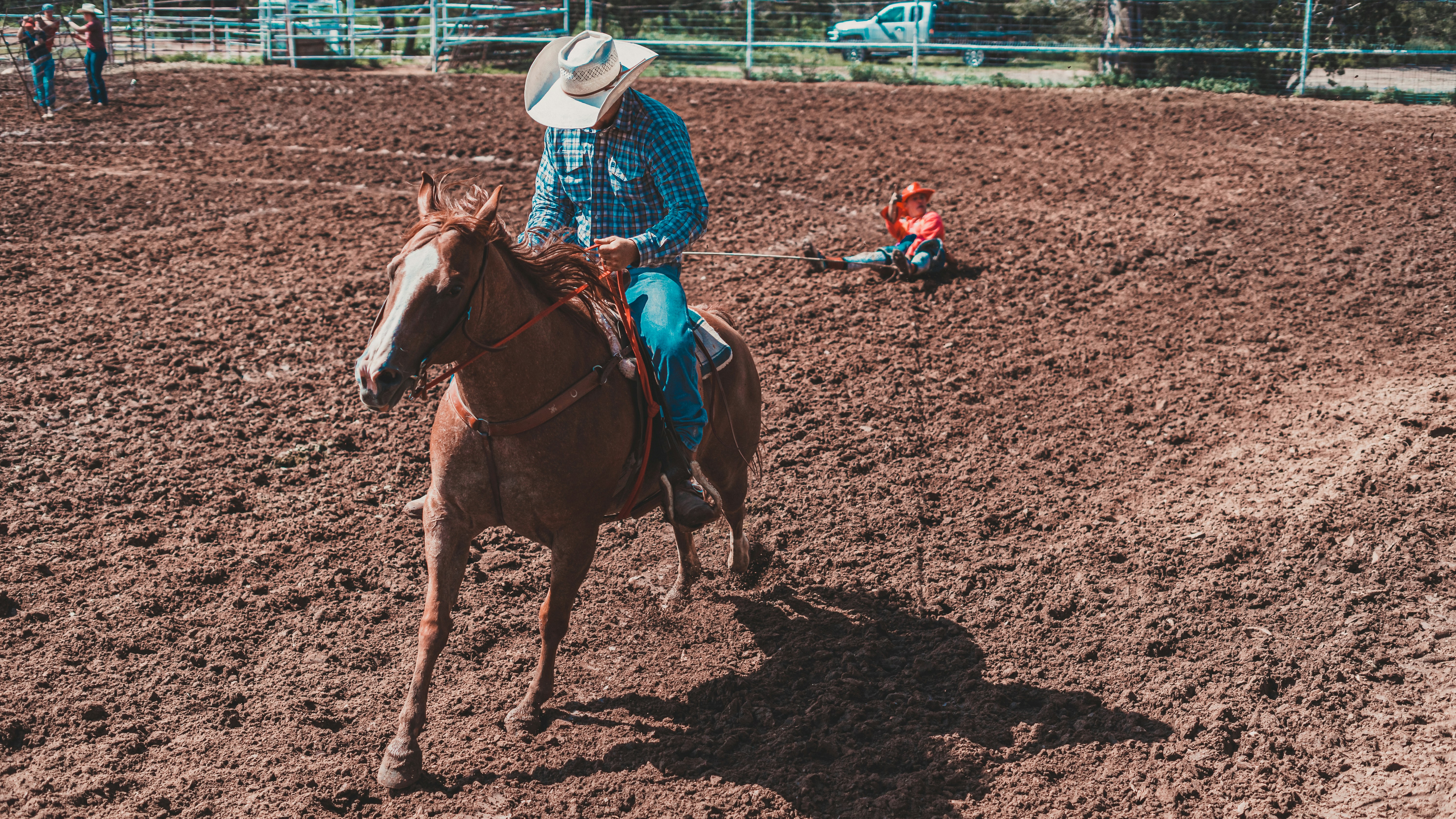 a man riding on the back of a brown horse