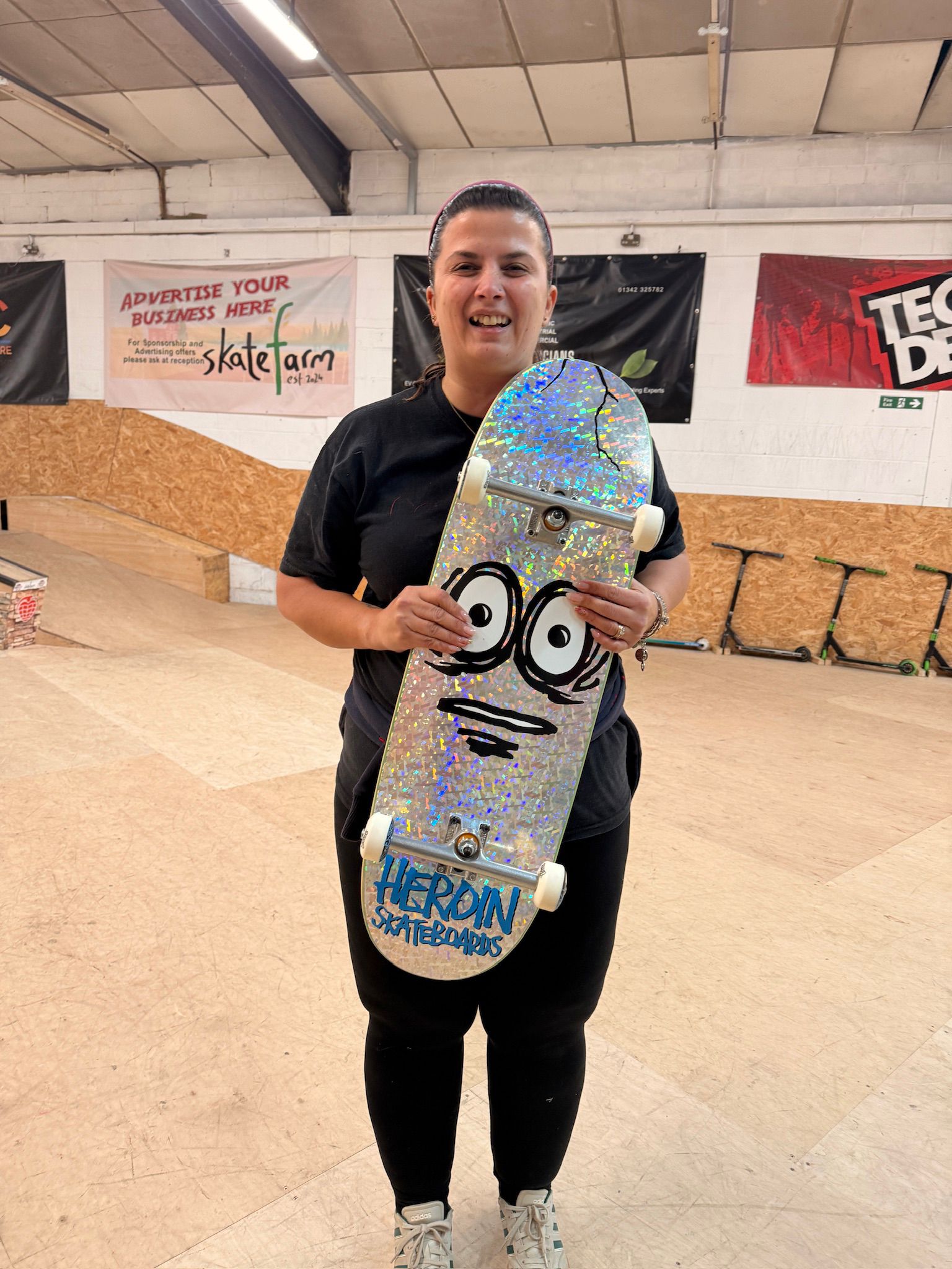 An adult skateboarder riding the ramp at The Skate Farm indoor skatepark in Haywards Heath
