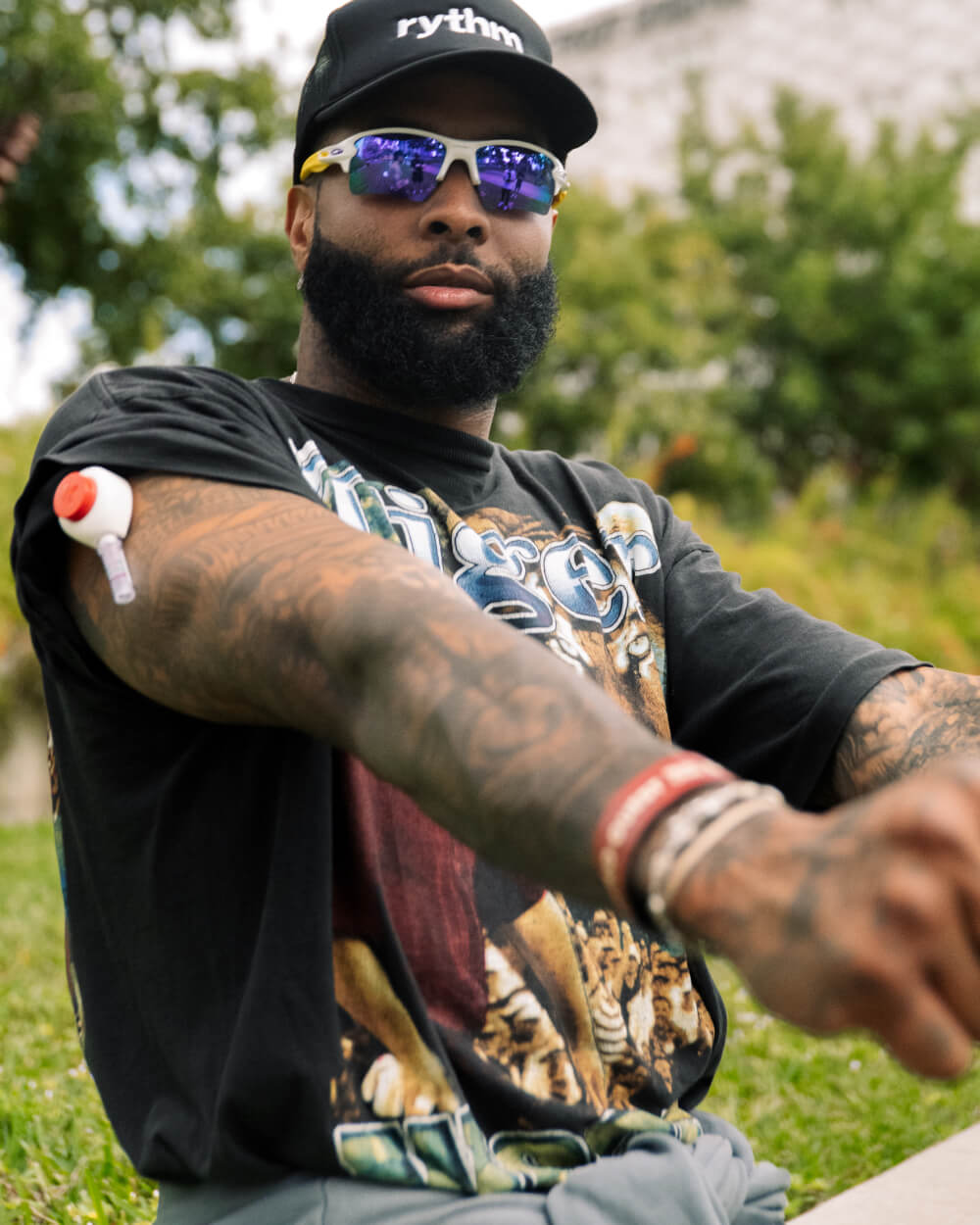 Caleb drinking from a bottle while standing on a snowy mountain trail.