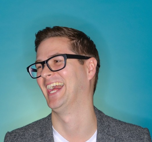 portrait of a man with glasses laughing