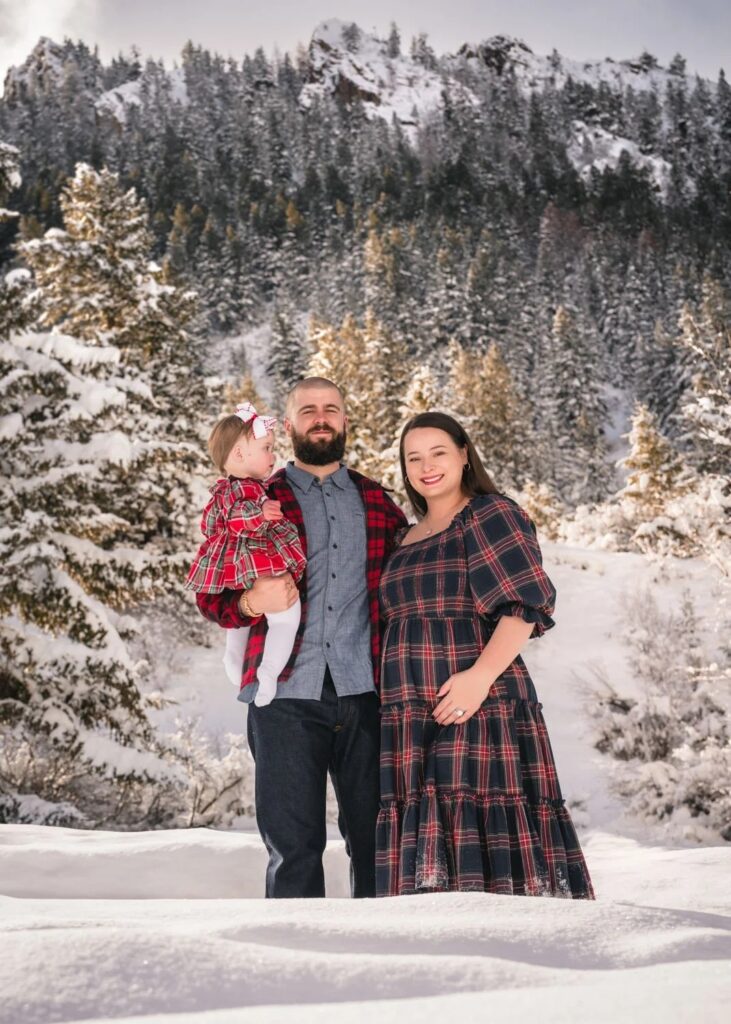 Family walking through snow-covered trees at an Aspen family portrait location