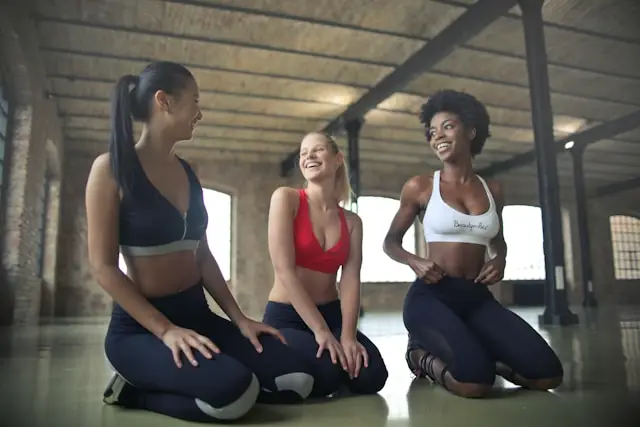Woman lying on an exercise ball during a fitness session, taking a moment to rest