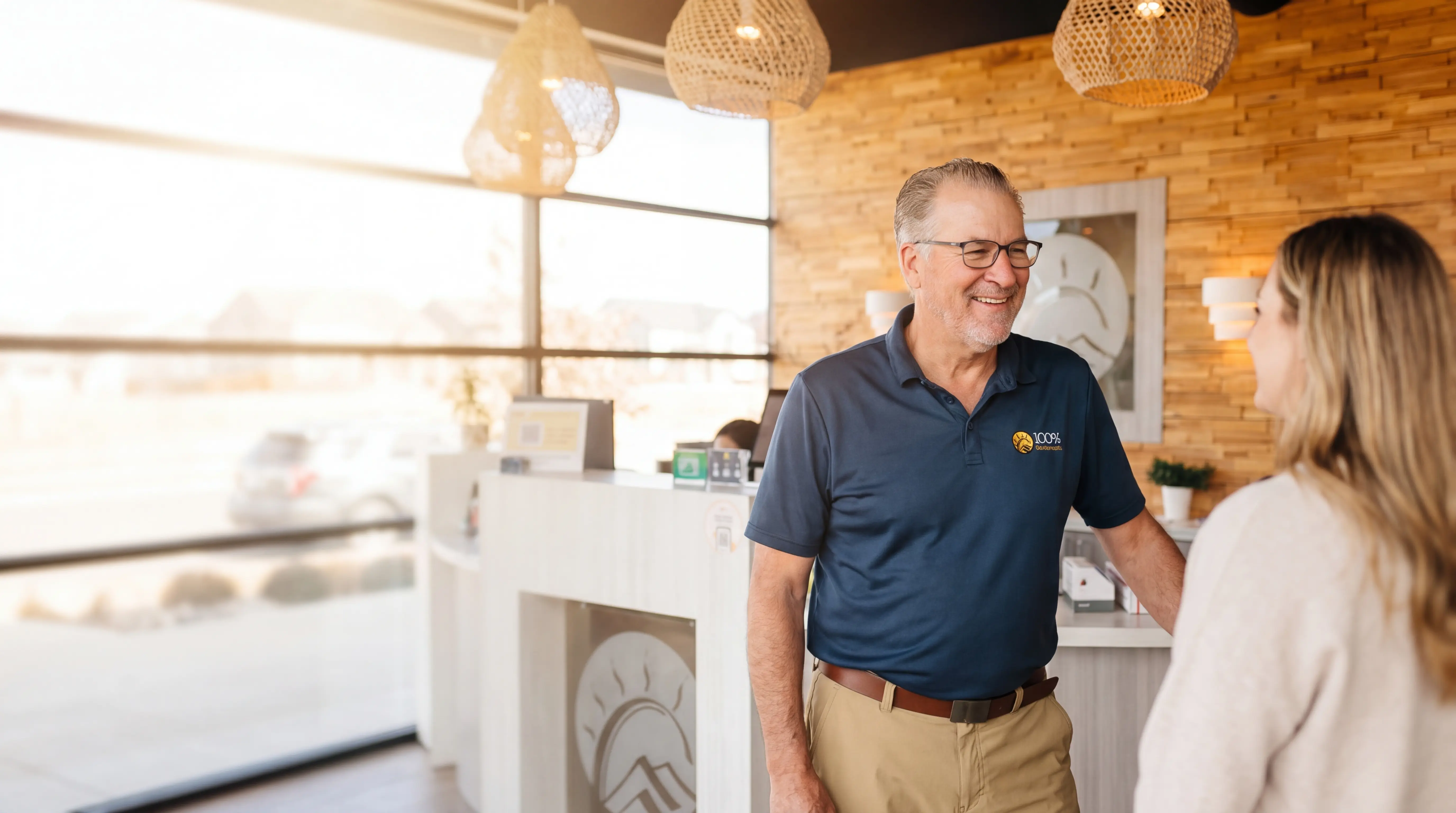 Chiropractor speaking with a patient in a warm, modern Denver clinic