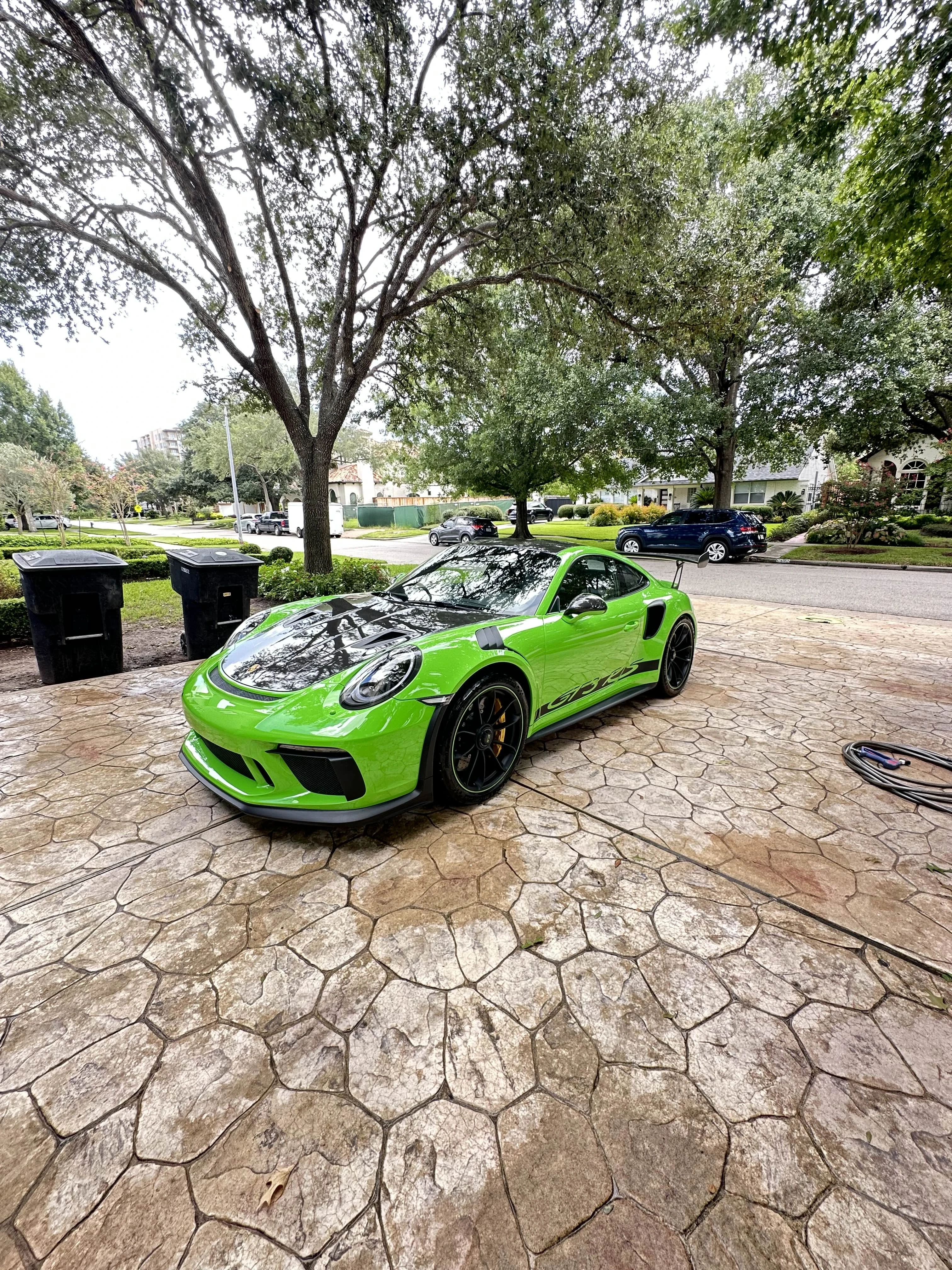 Front view of a freshly washed Porsche 911 GT3 RS parked on a residential driveway during a Houston mobile car wash service.