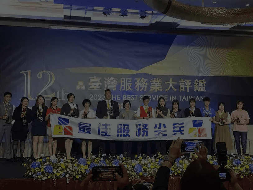Modern bathroom featuring a walk-in shower, wooden vanity, round mirror, and elegant marble tiles.
