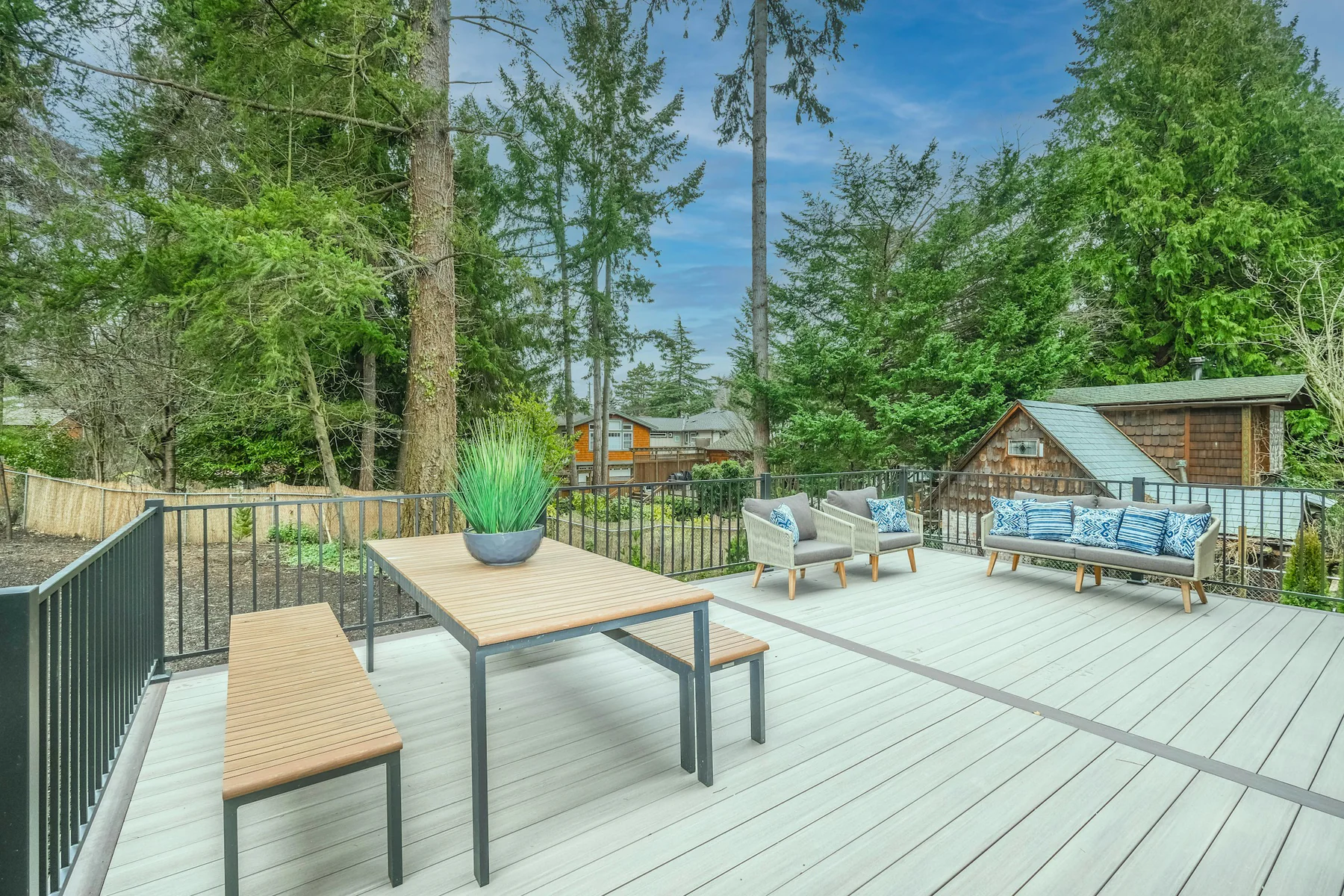 Light-colored deck with outdoor seating in summer