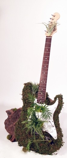 small electric guitar with musk on it