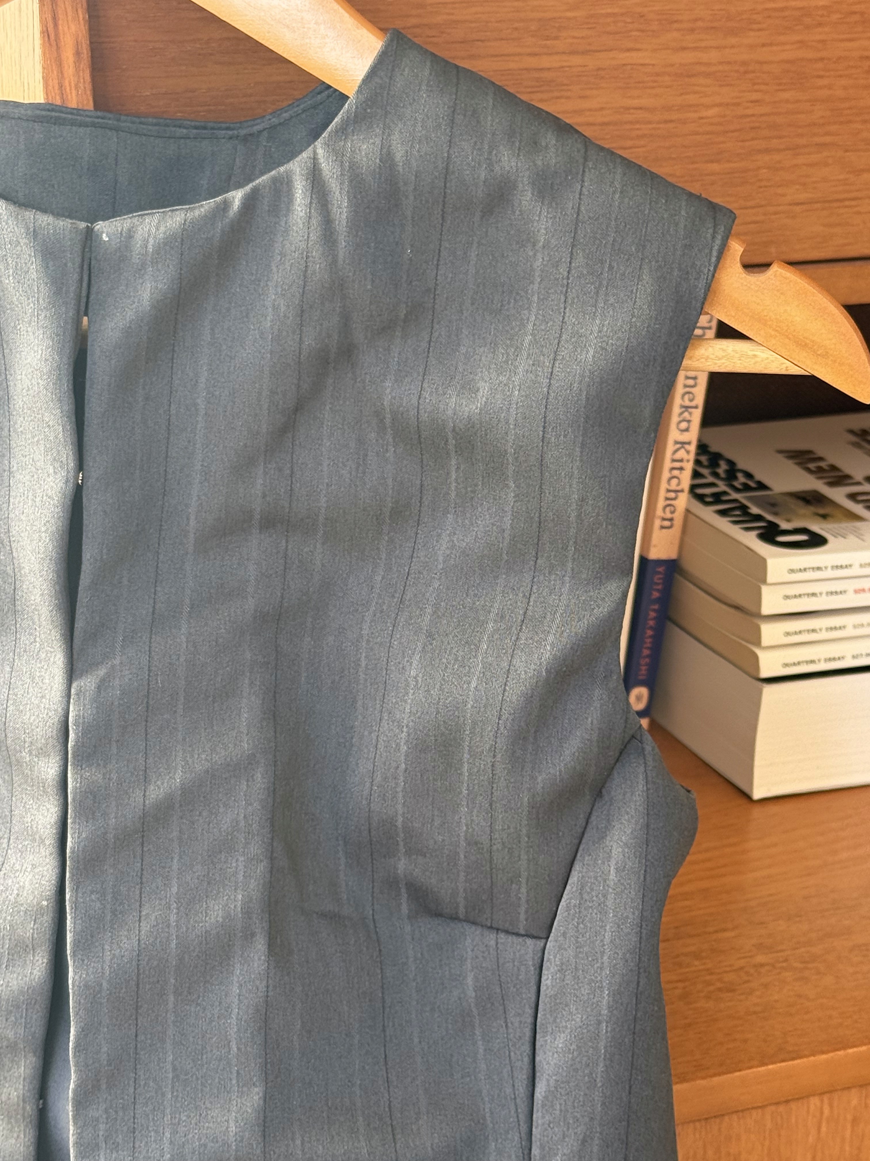 Close-up of black pin-stripe sleevless vest 