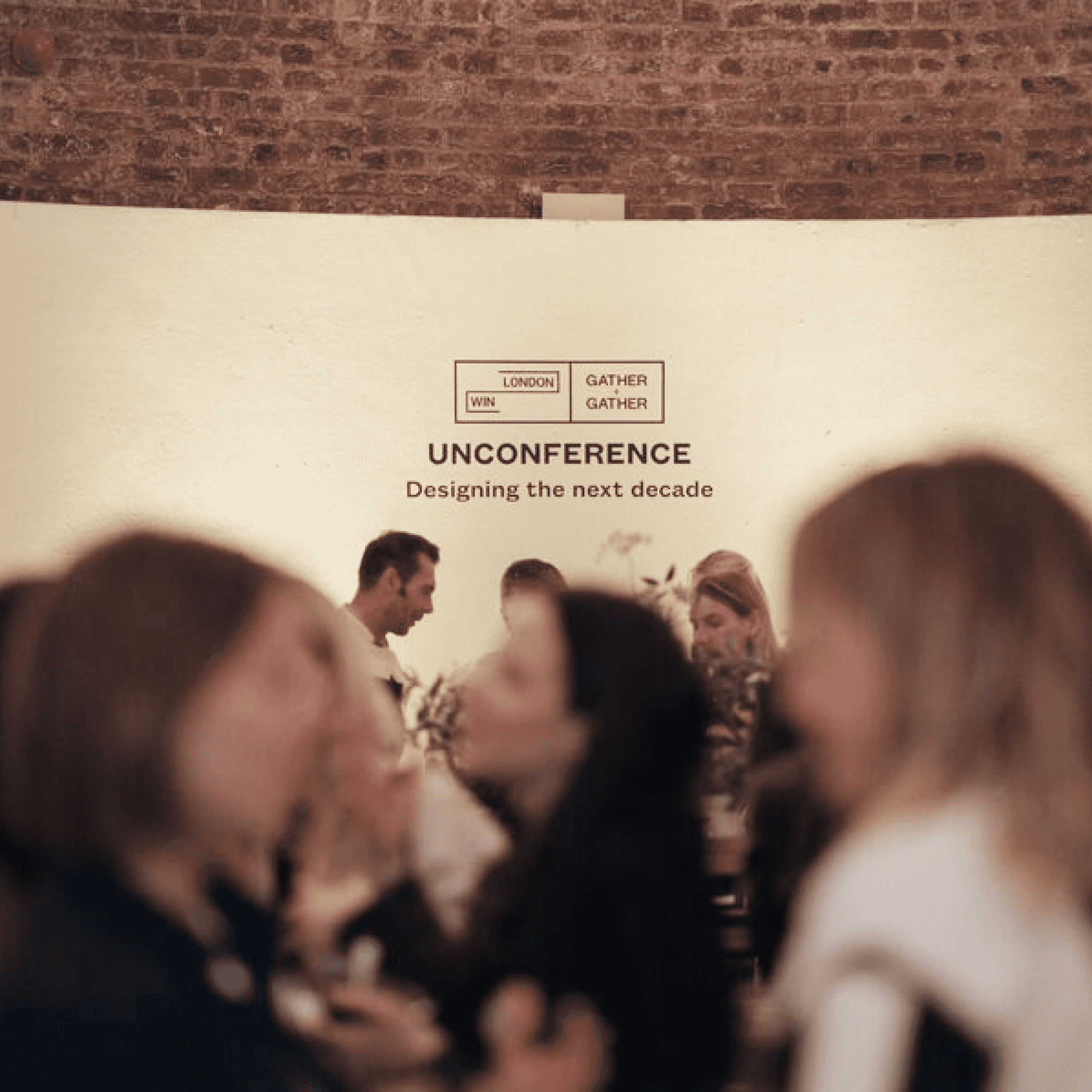A hand writes on sticky notes on a table, surrounded by various colored papers and notes.