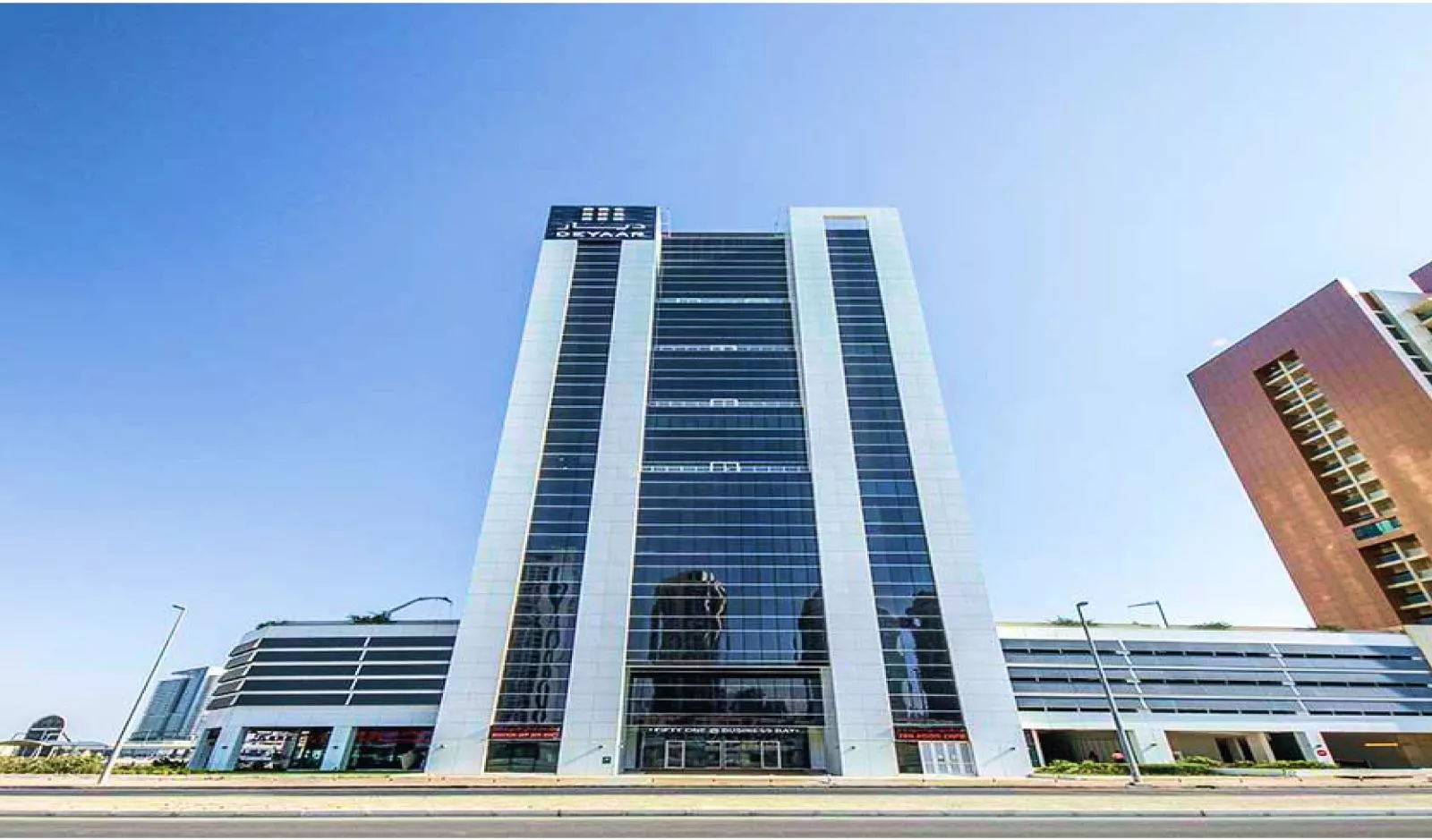 Ground view of Fifty One Tower from retail. High visibility office and restaurant spaces available. Agent listings.