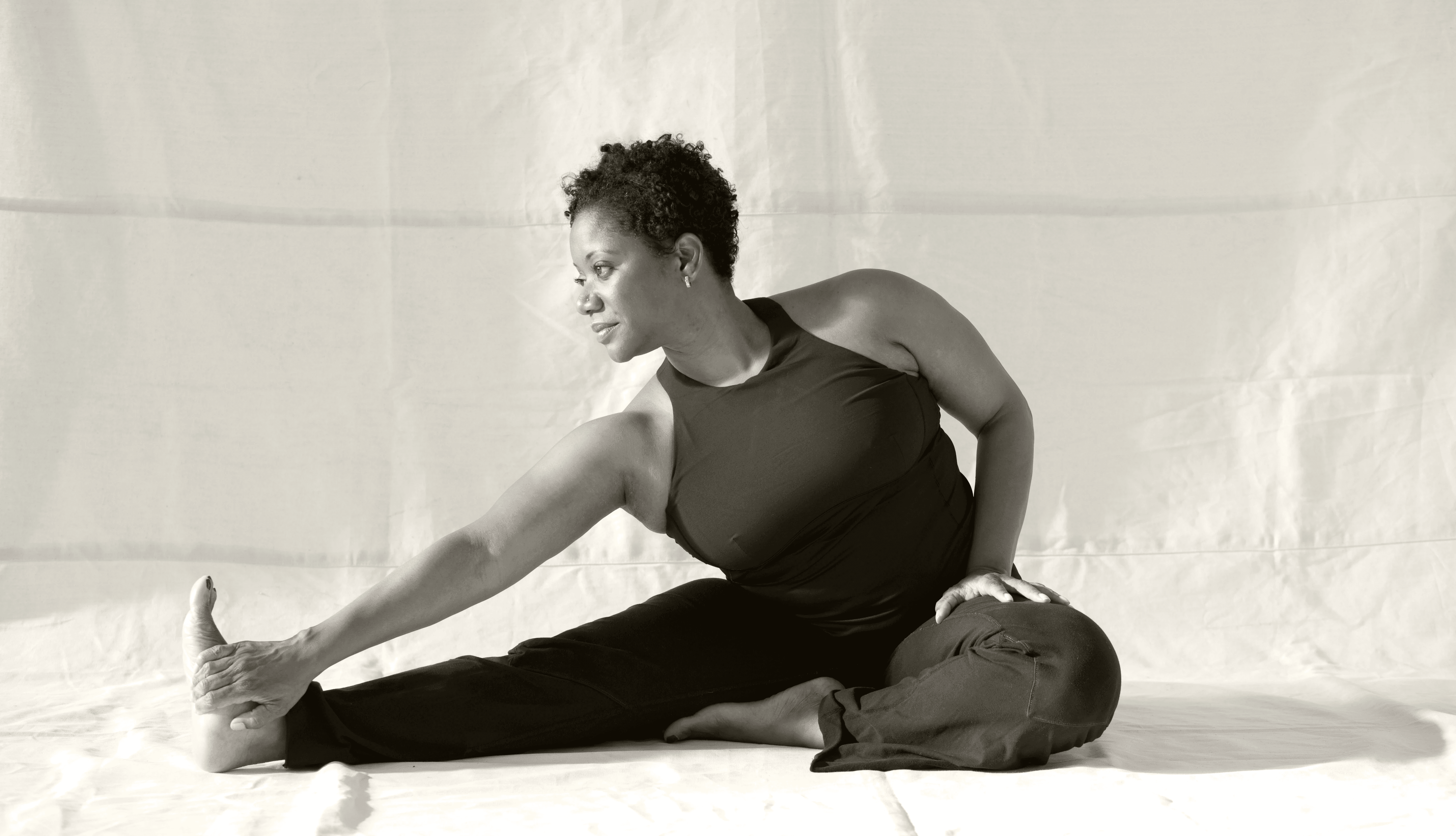 man in black suit jacket holding white ceramic mug