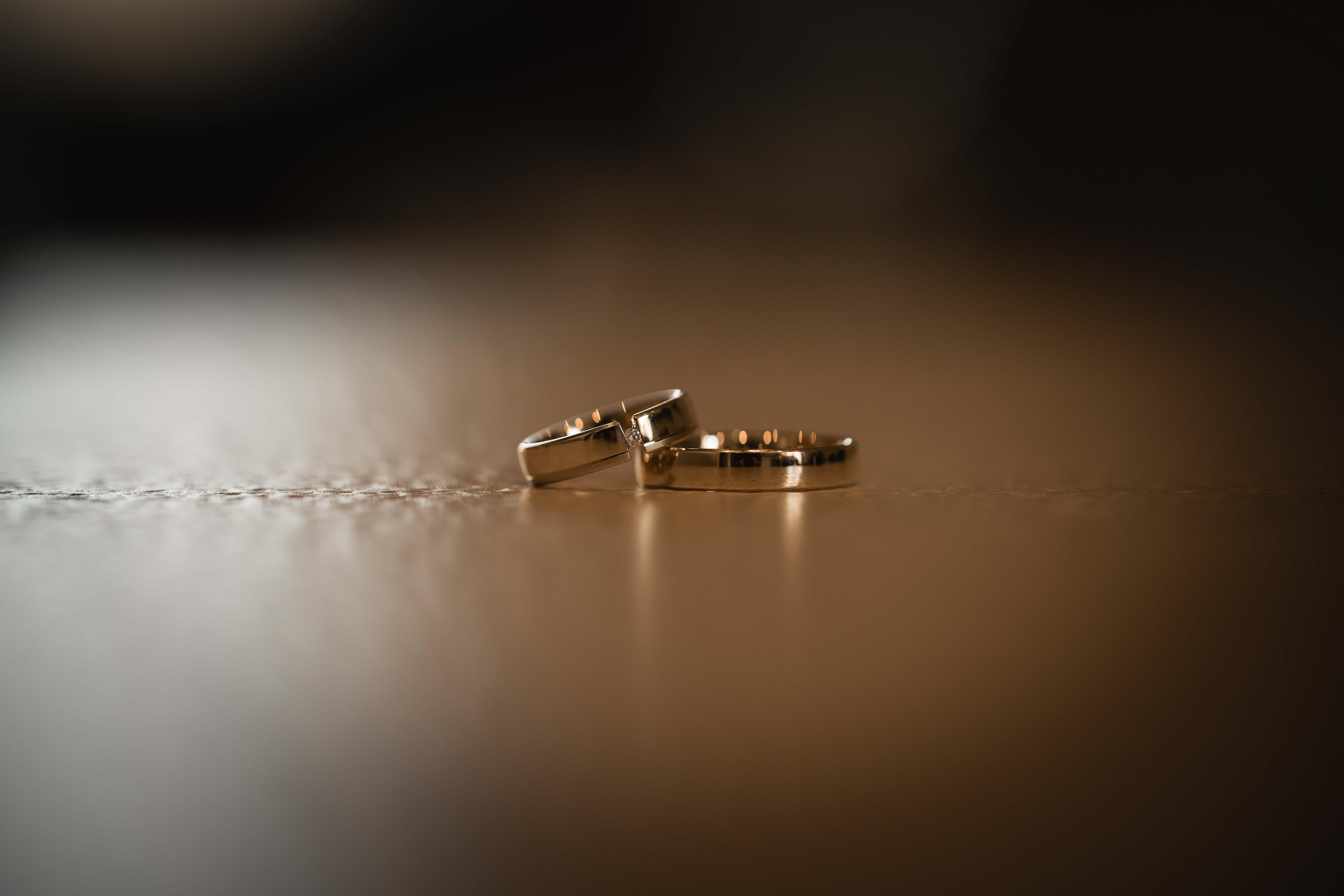 A vibrant bridal bouquet featuring a mix of red, pink, and purple flowers.