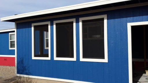 Freshly painted blue home exterior with white trim in Tucson