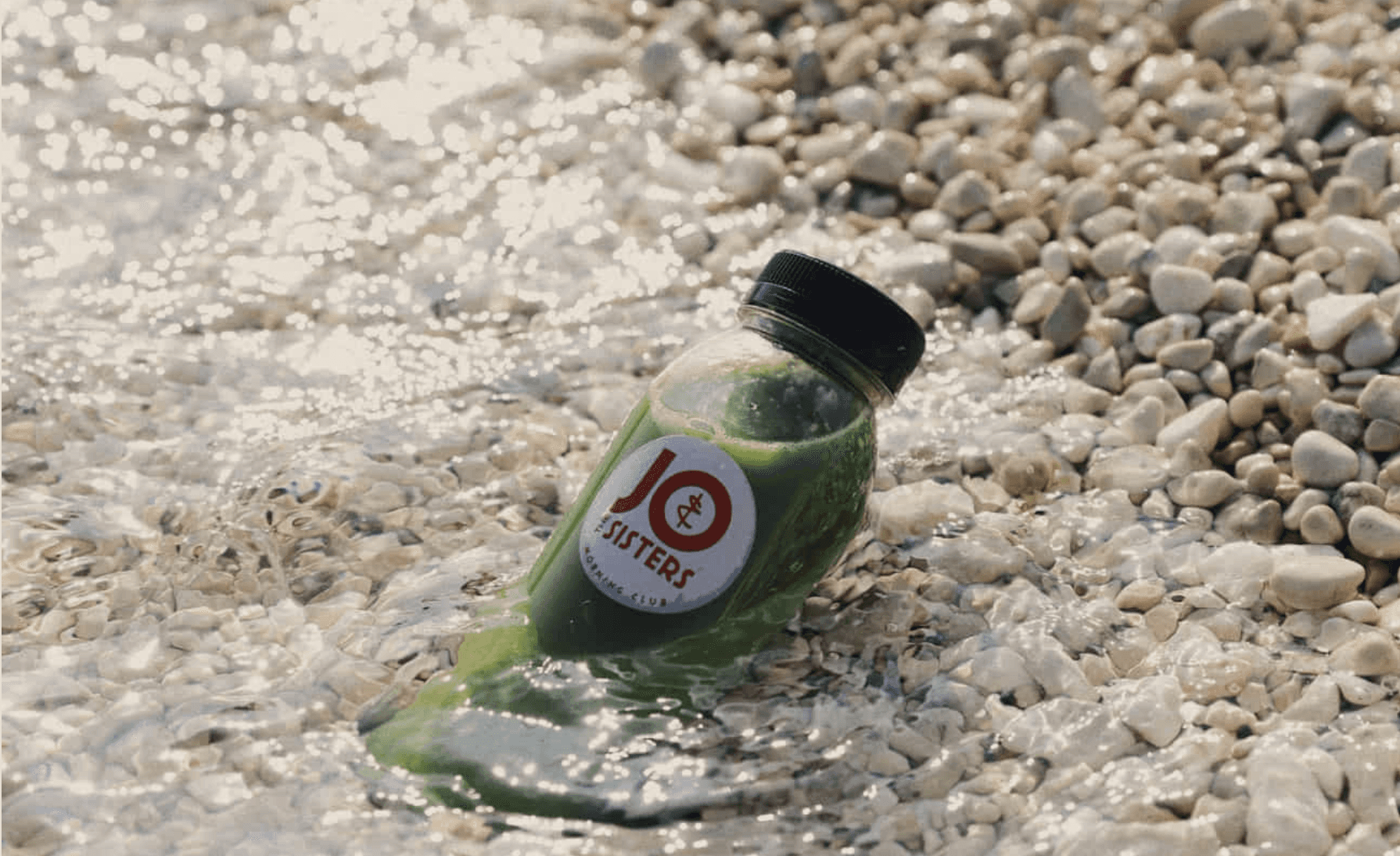 Cold-pressed green juice from Jo & The Sisters on a sunny Split beach