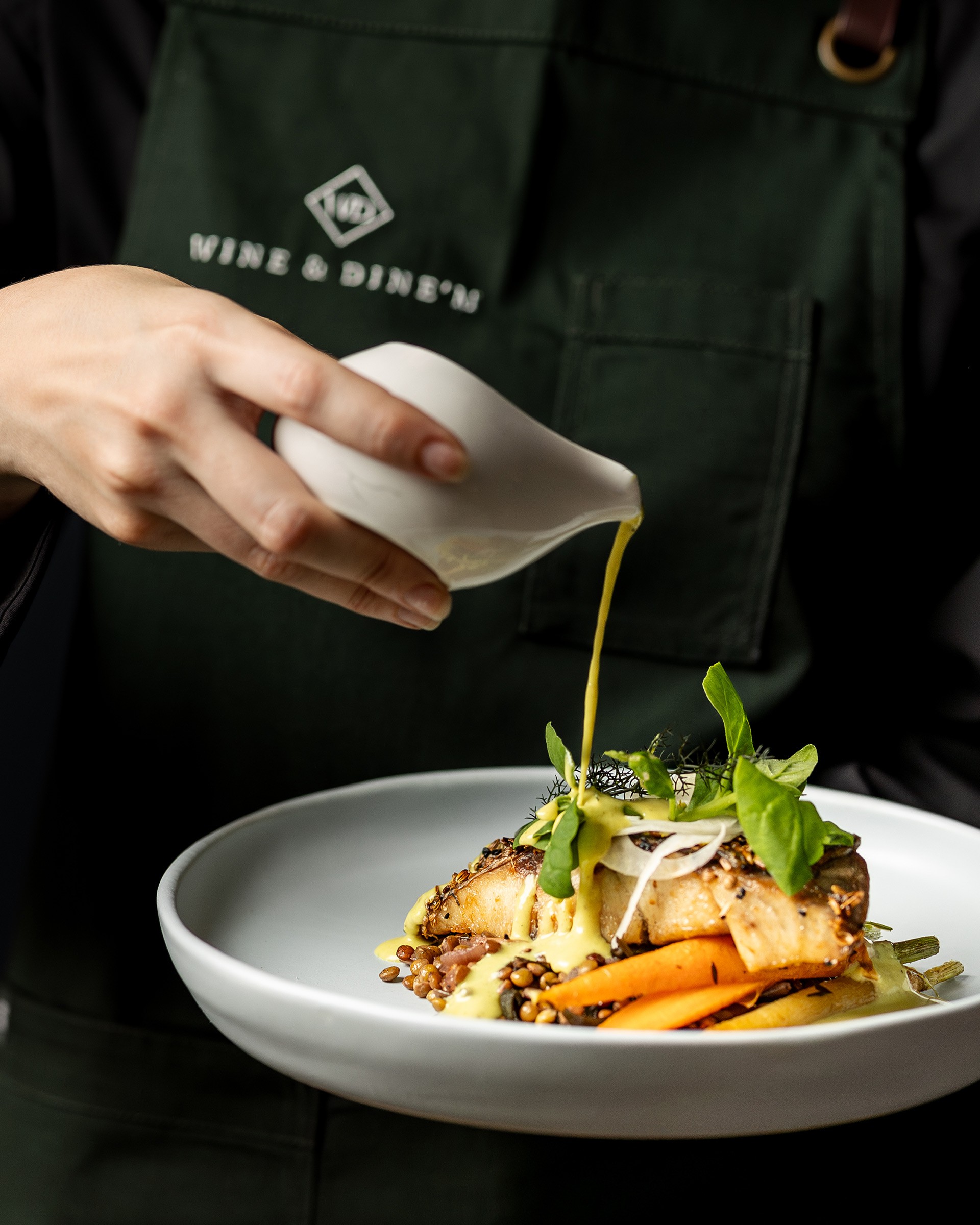 Pouring Native Curry over a Seed-Crusted Barramundi Main