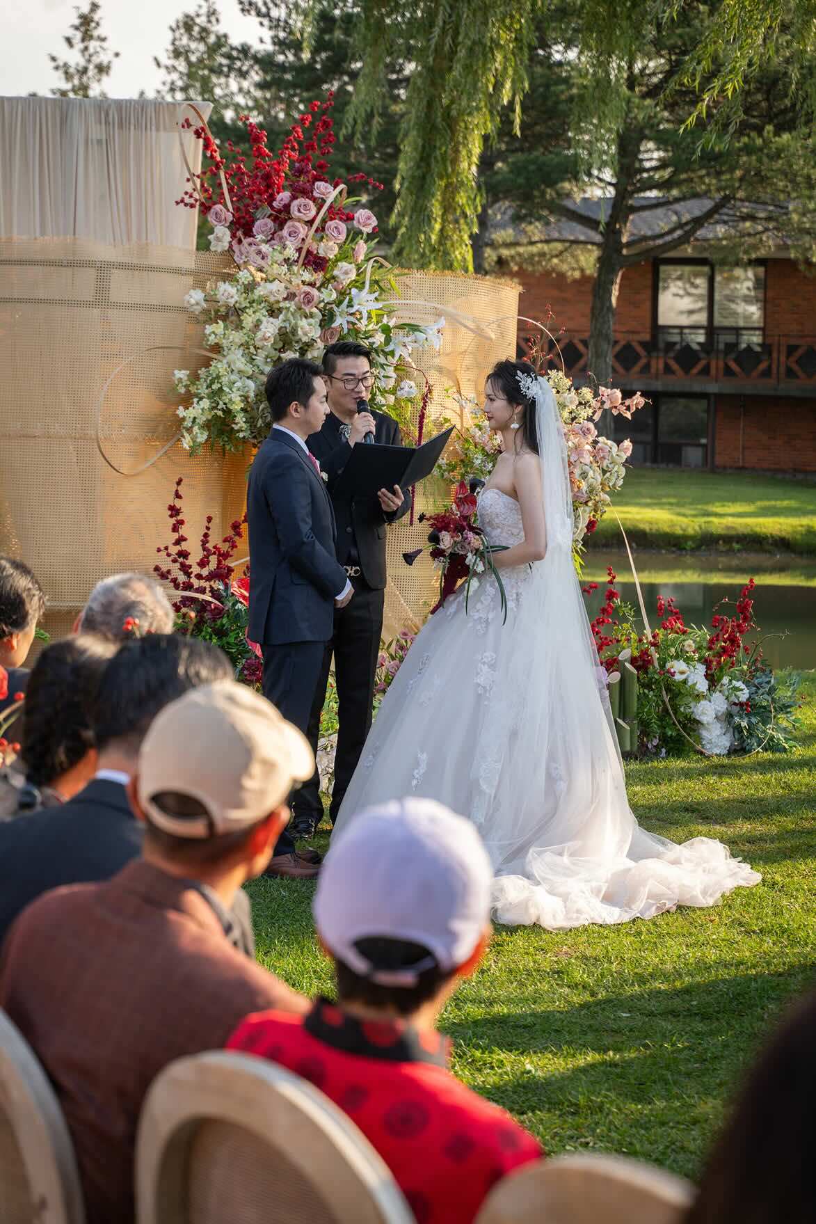 A bride and groom share a kiss surrounded by a joyful bridal party.