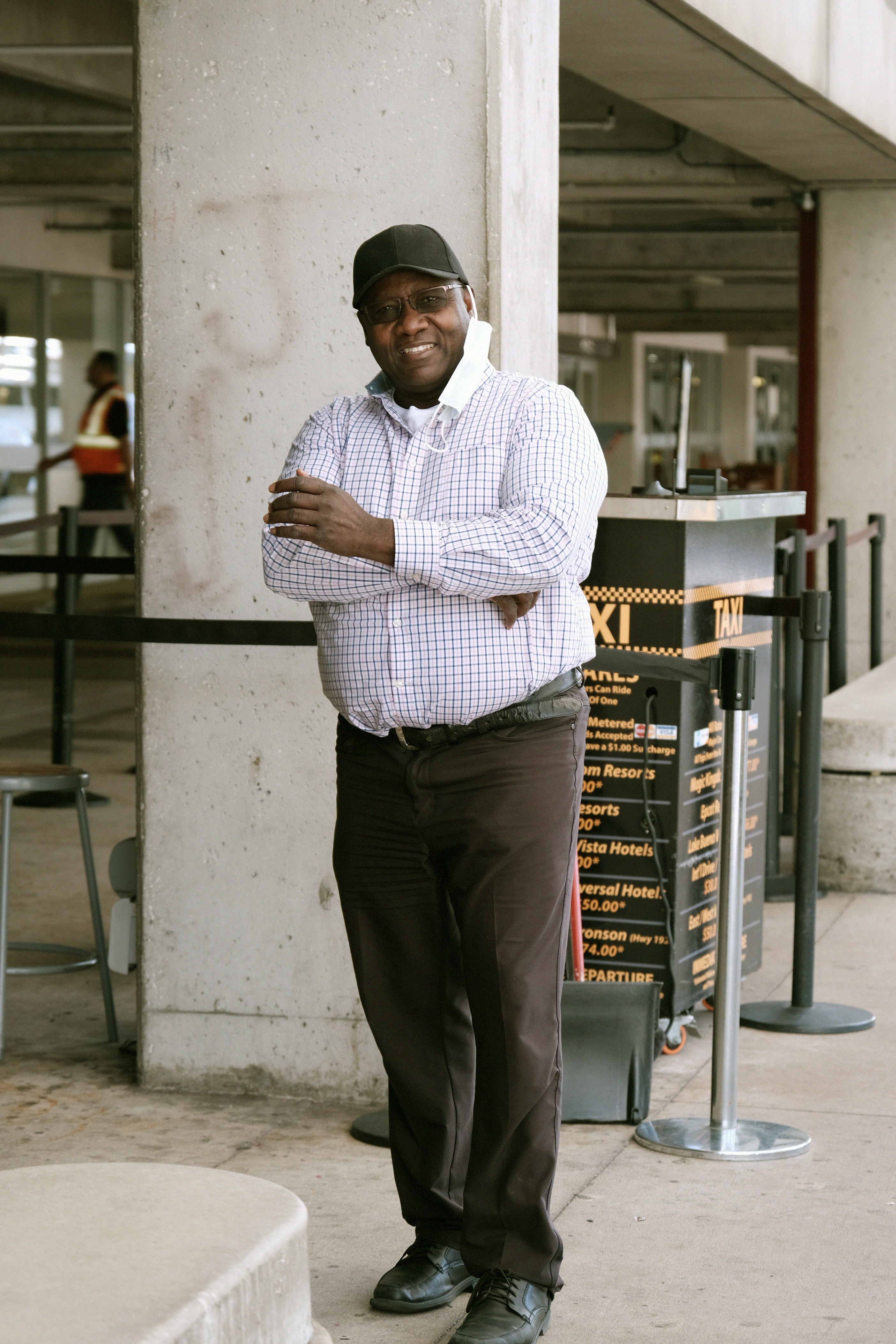 a man standing in front of a tall building