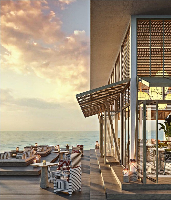 Modern seaside restaurant terrace at sunset with warm lighting and ocean view | Lunasole Hospitality