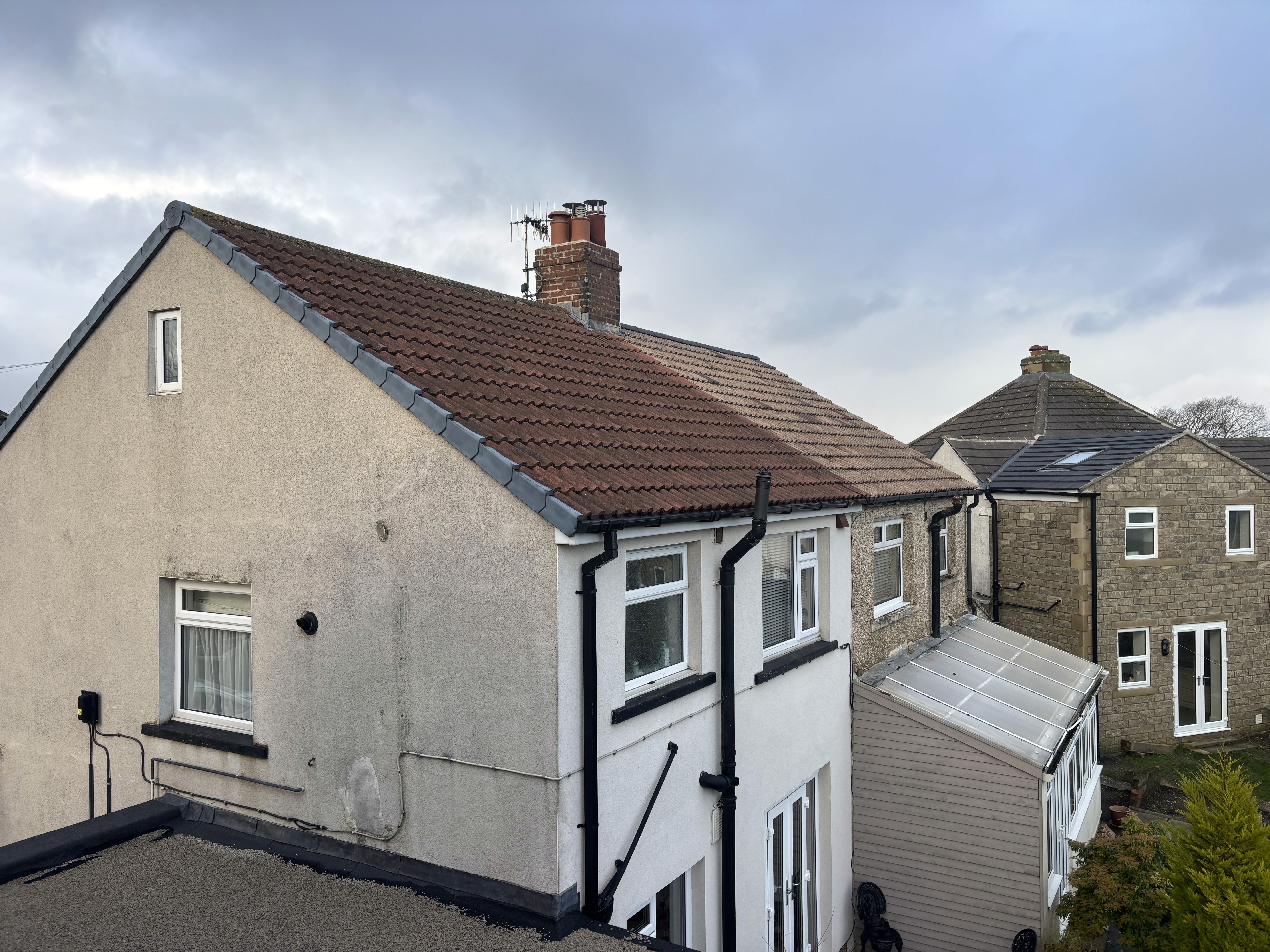 Clean roof tiles after professional moss scraping and biocide treatment