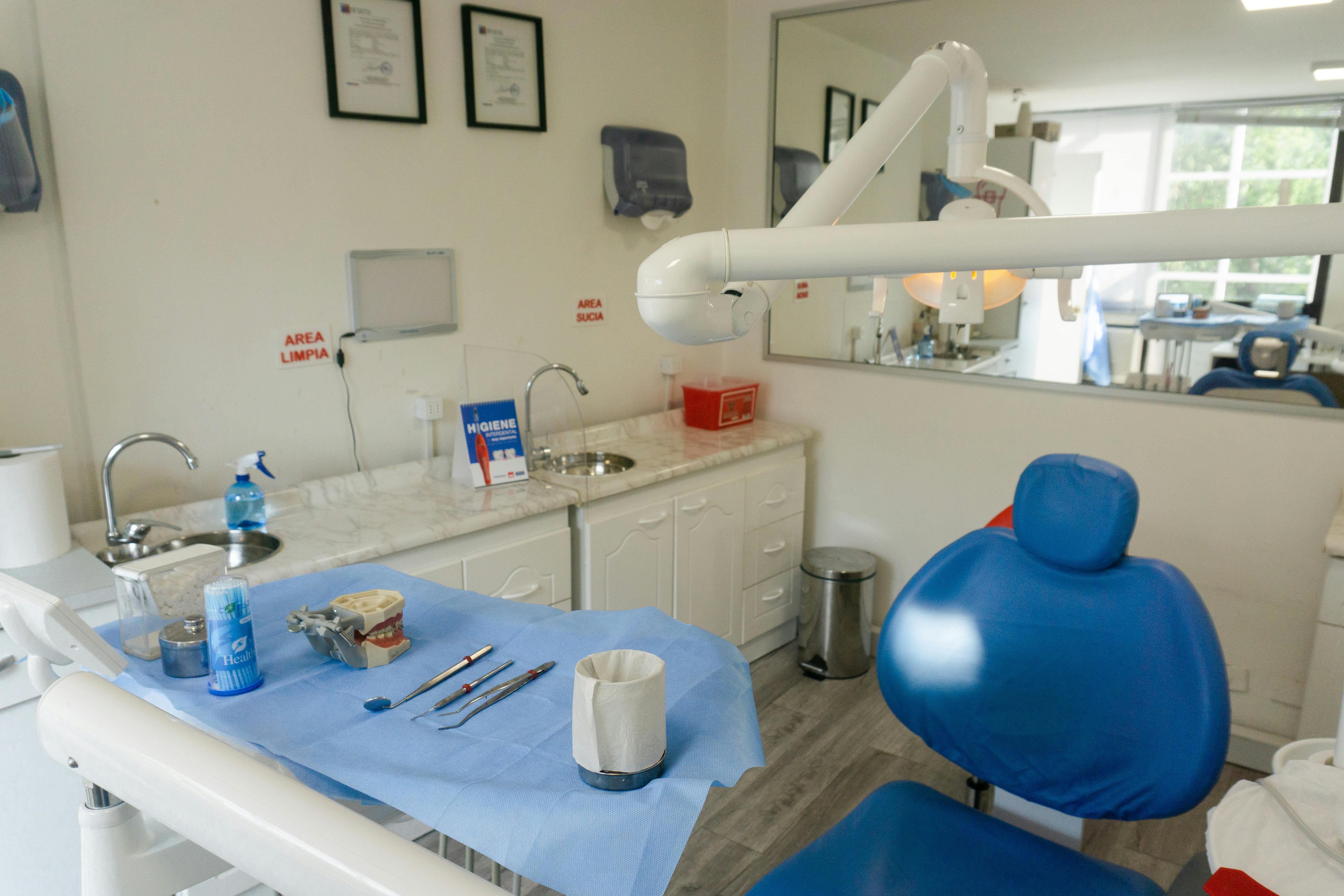 dental teeth cleaning room with chair and instruments