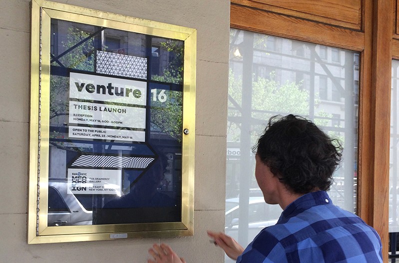 a person looking at the venture 16 event poster in the streets