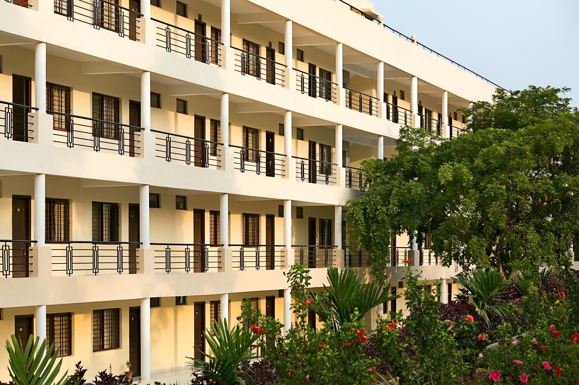 Aerial view of a winding road cutting through rocky terrain with patches of grass.