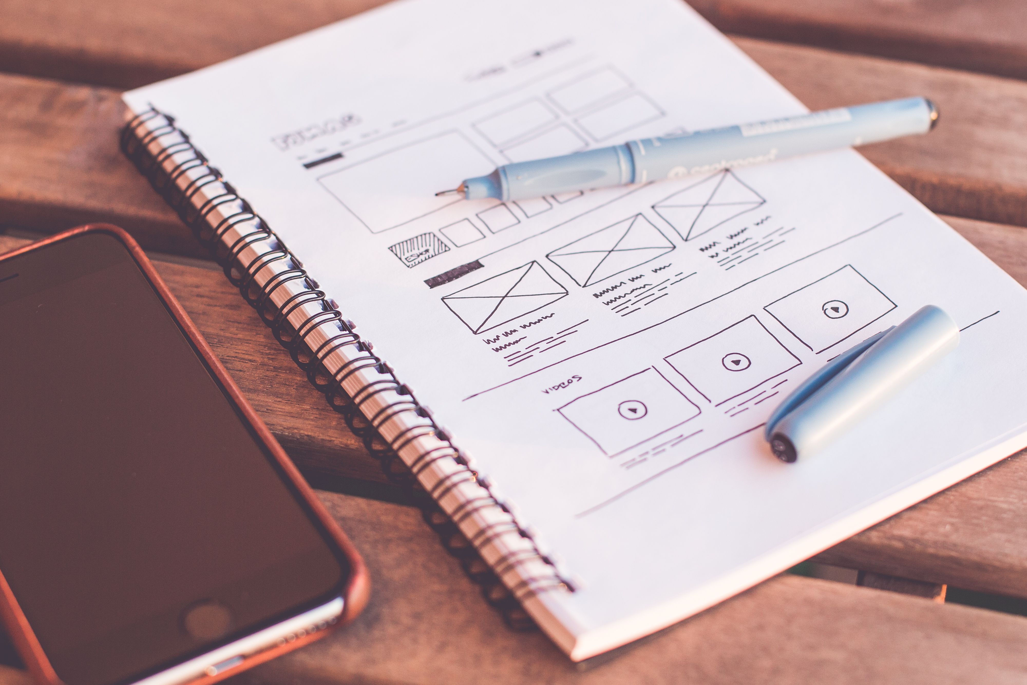 Website wireframe sketches in a notebook