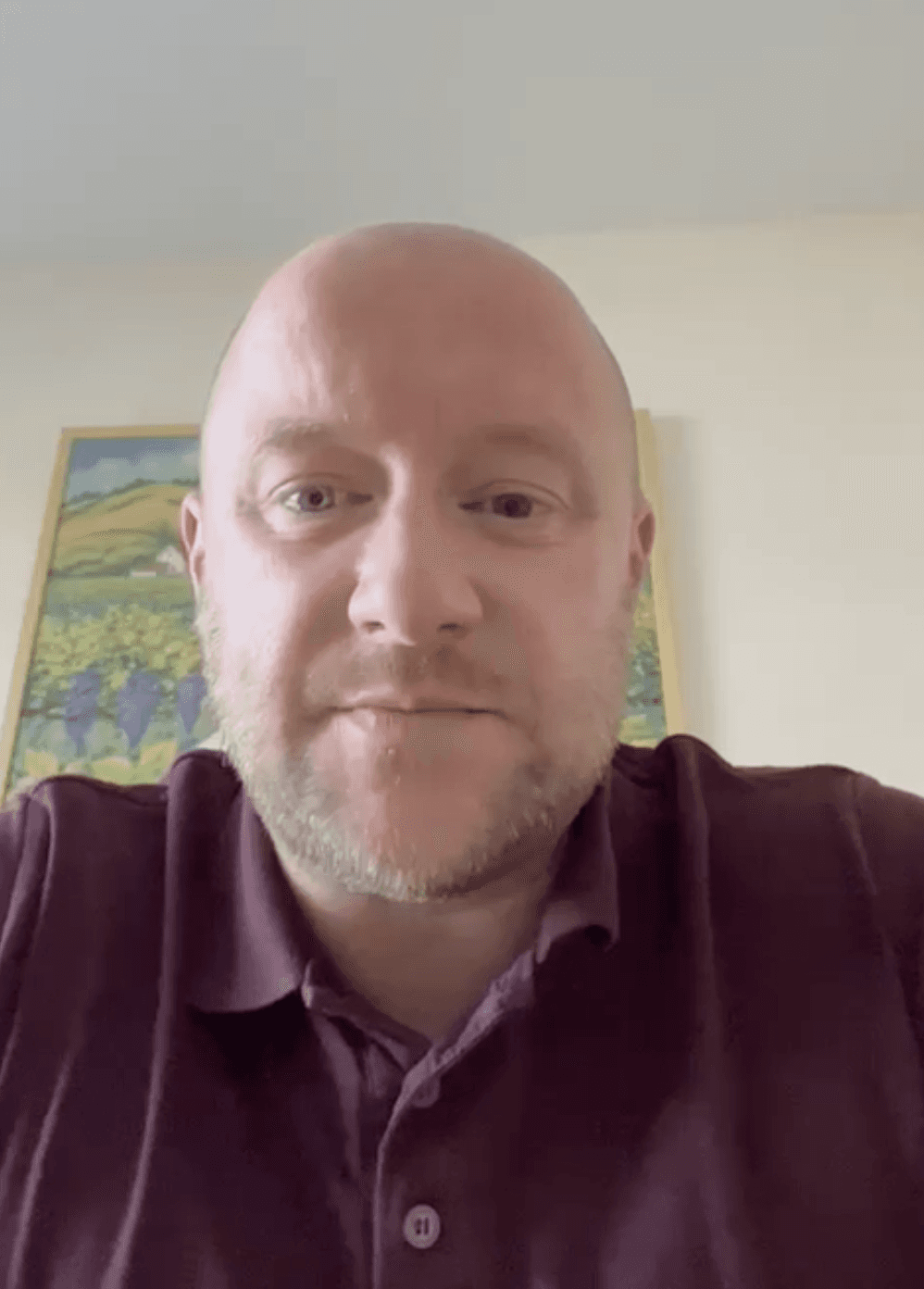 A man works on a laptop in an office.