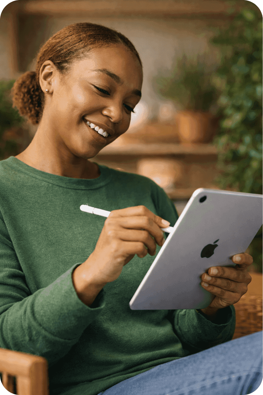 Lady smiling and taking notes on her tablet