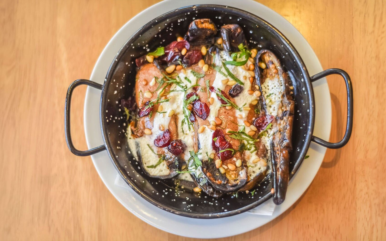 Gourmet dish with eggplant, pine nuts, and cranberries on a 3.5-hour art tour.