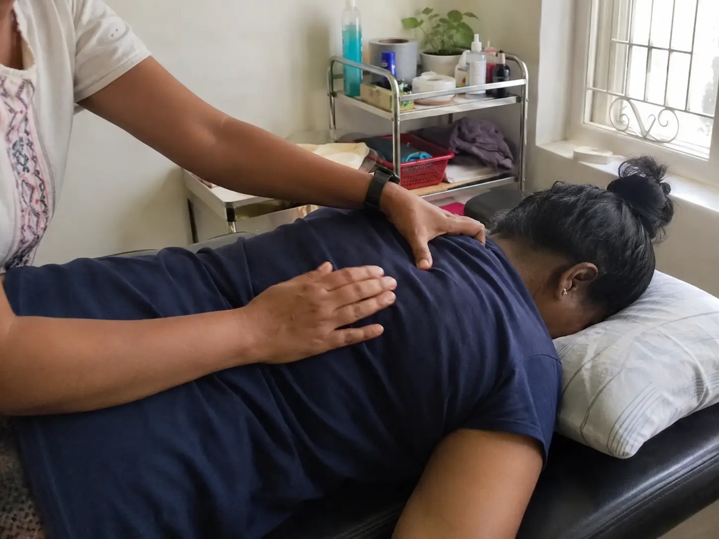 therapist assisting with back treatment
