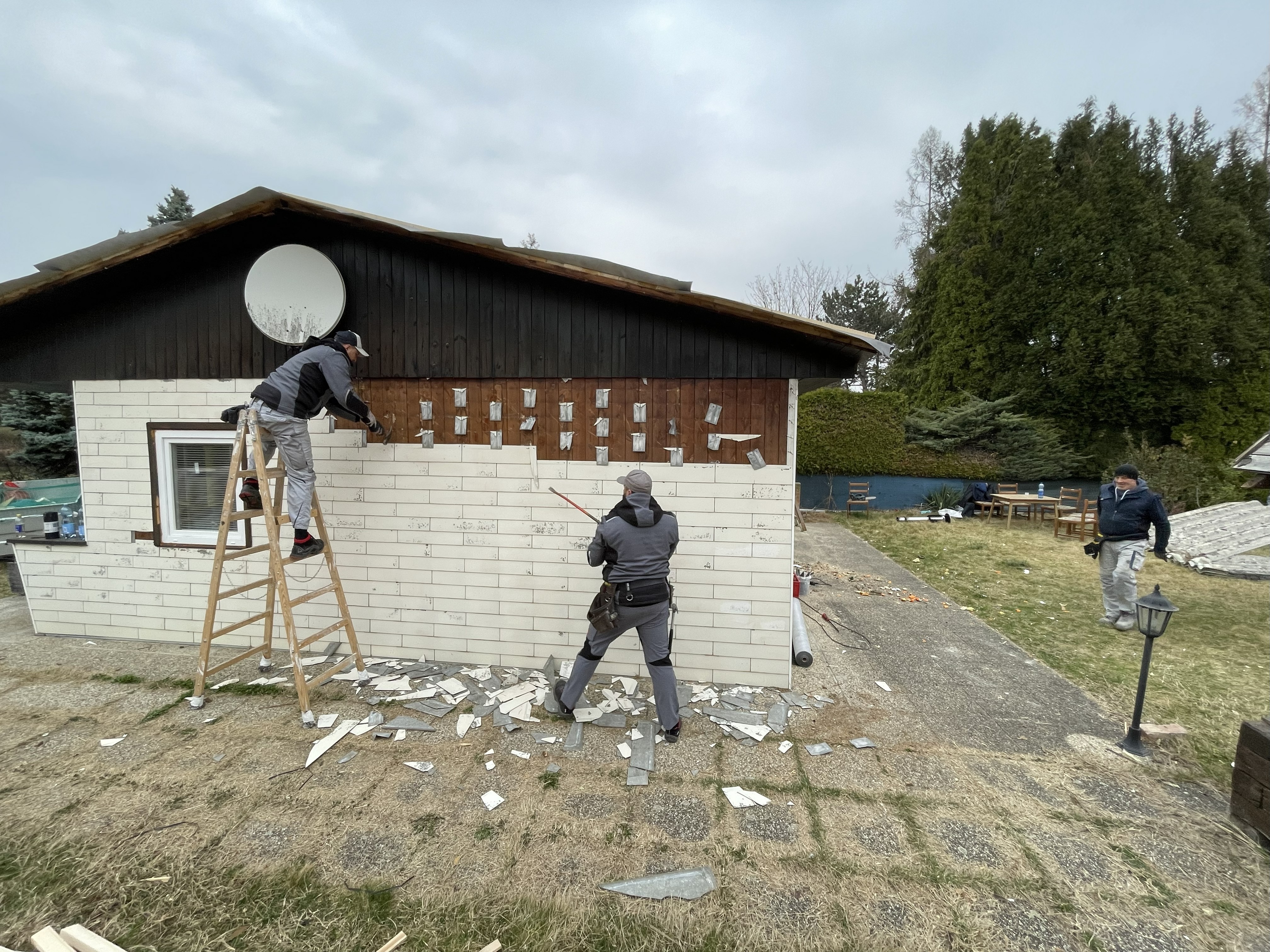Montage von Wärmedämmplatten an der Außenfassade eines Hauses während der Sanierung.