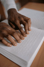 Person reading a braille book