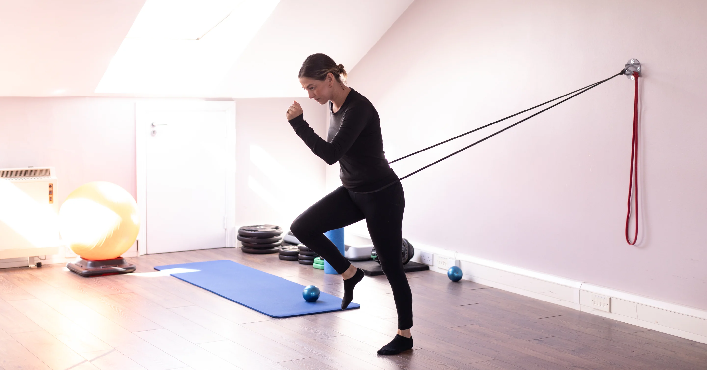 A client working through a resistance band exercise in the Total Physio rehabilitation gym in Sandyford